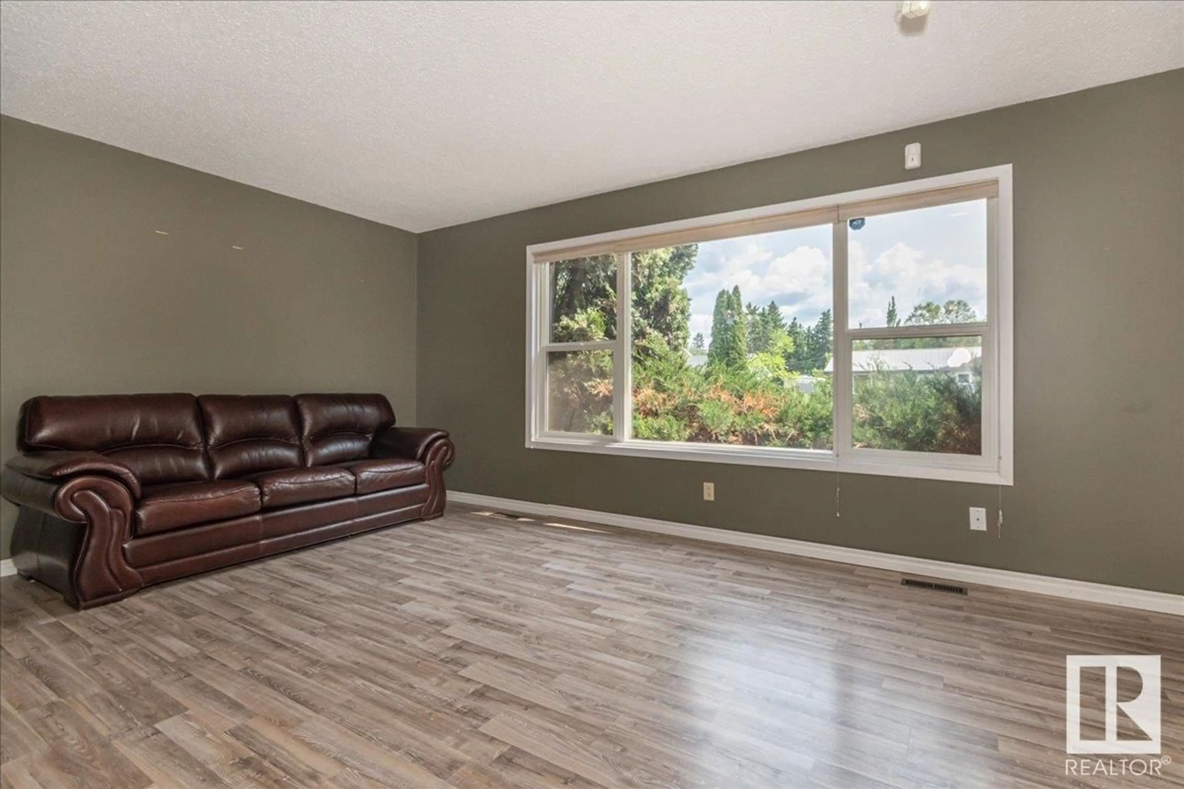 Living room with furniture, wood/laminate floor for 5204 55A ST, Wetaskiwin Alberta T9A1T9