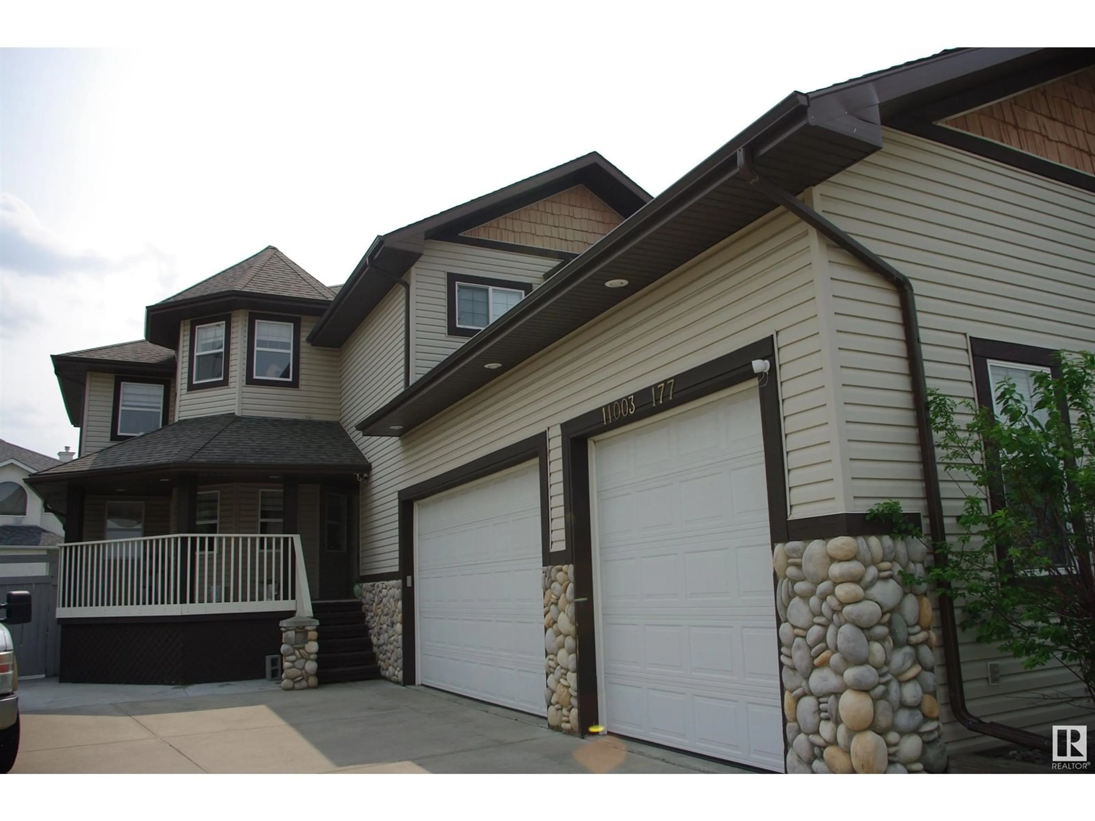 Home with vinyl exterior material, street for NW - 11003 177 AV, Edmonton Alberta T5X6H5
