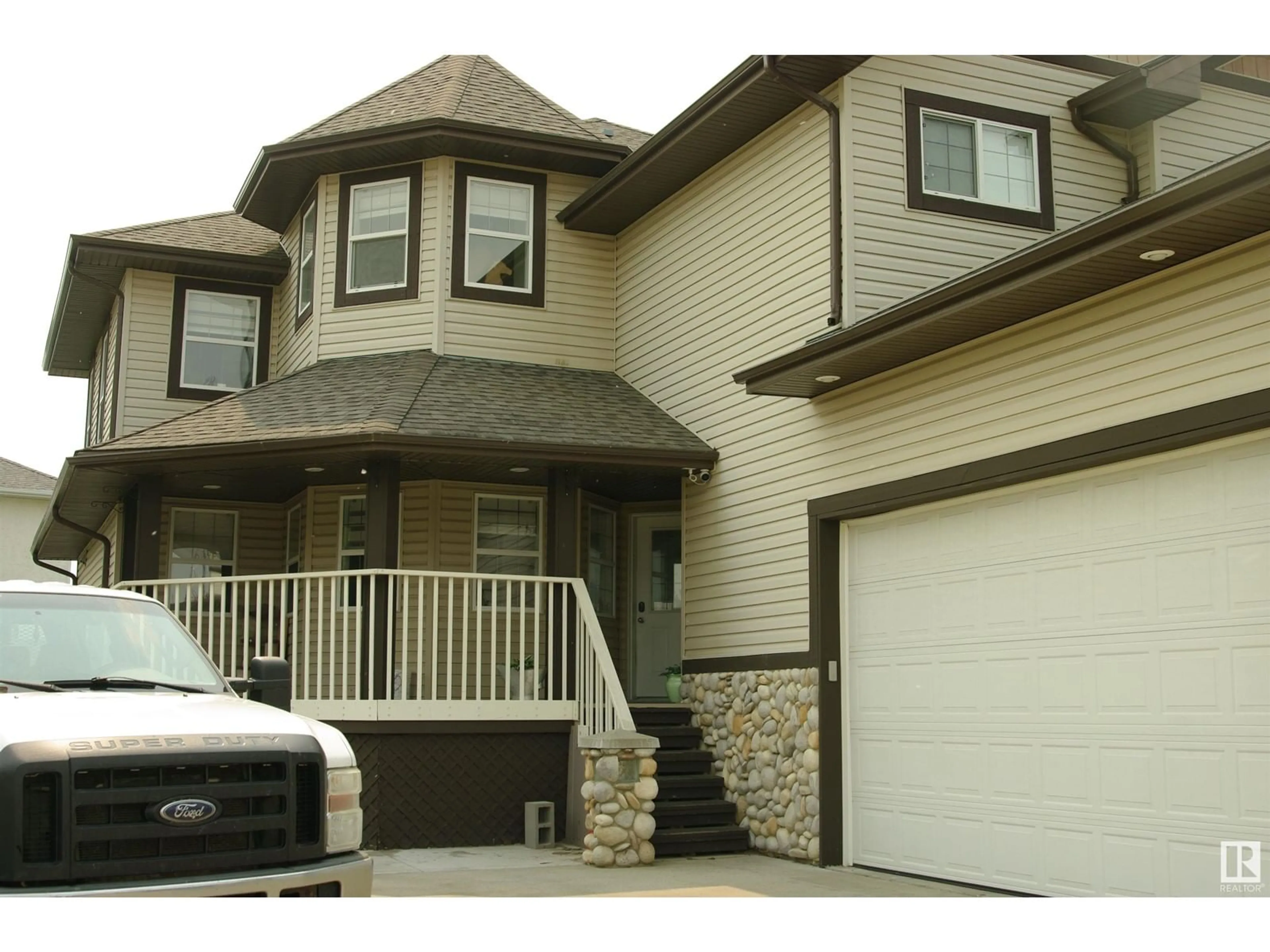 Home with vinyl exterior material, street for NW - 11003 177 AV, Edmonton Alberta T5X6H5