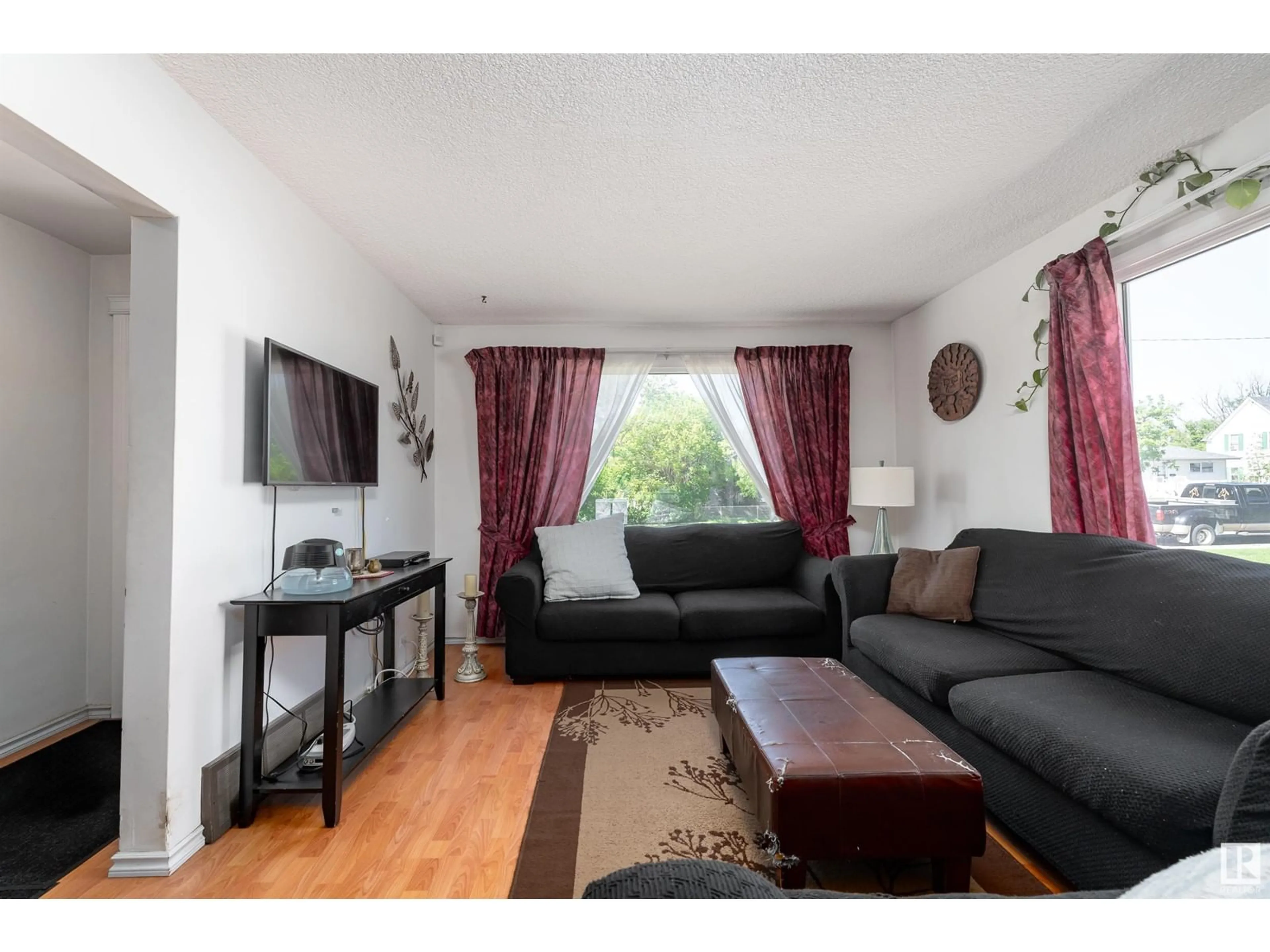 Living room with furniture, wood/laminate floor for 4527 46 AV, Leduc Alberta T9E5V7