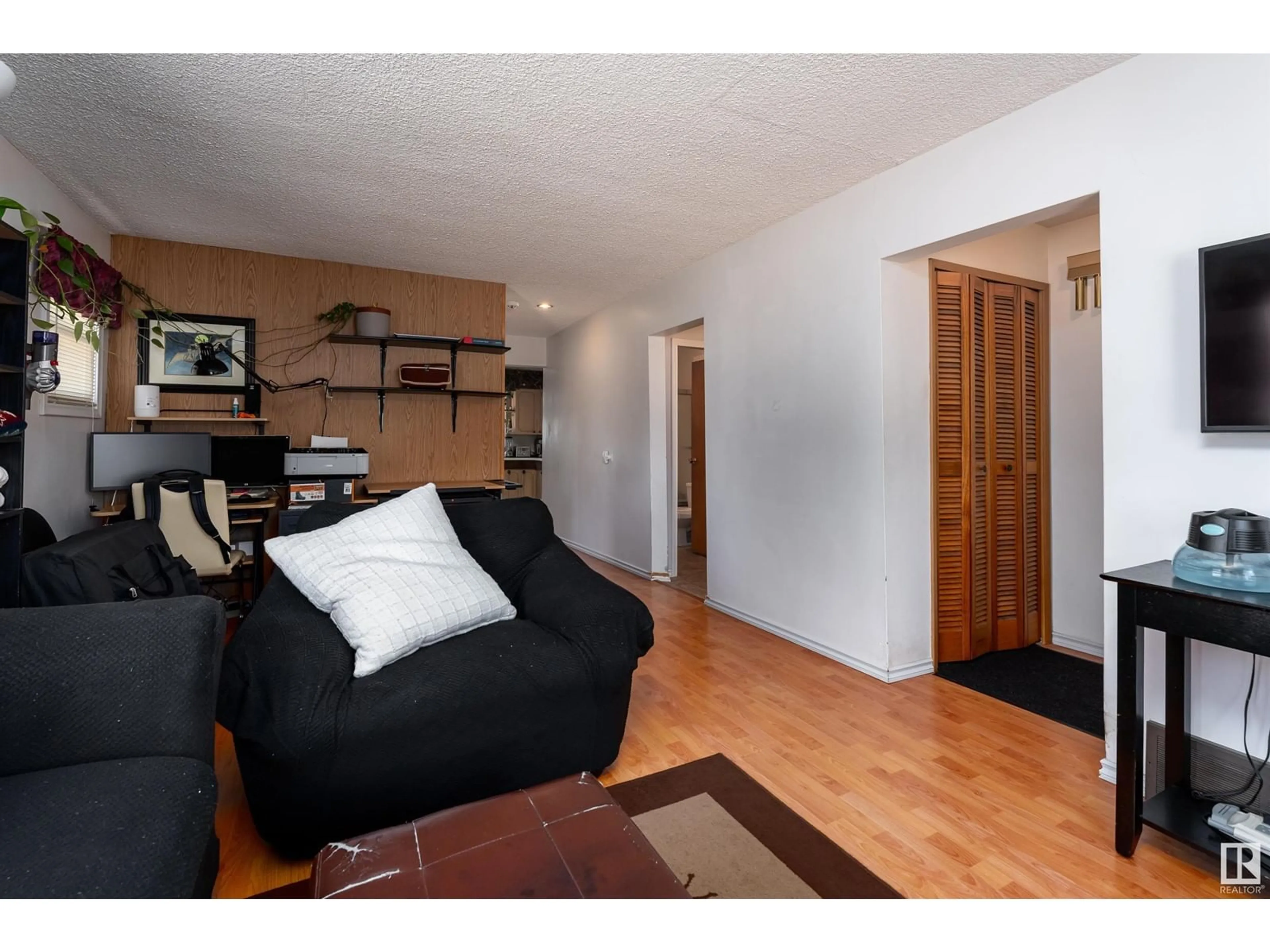 Living room with furniture, wood/laminate floor for 4527 46 AV, Leduc Alberta T9E5V7