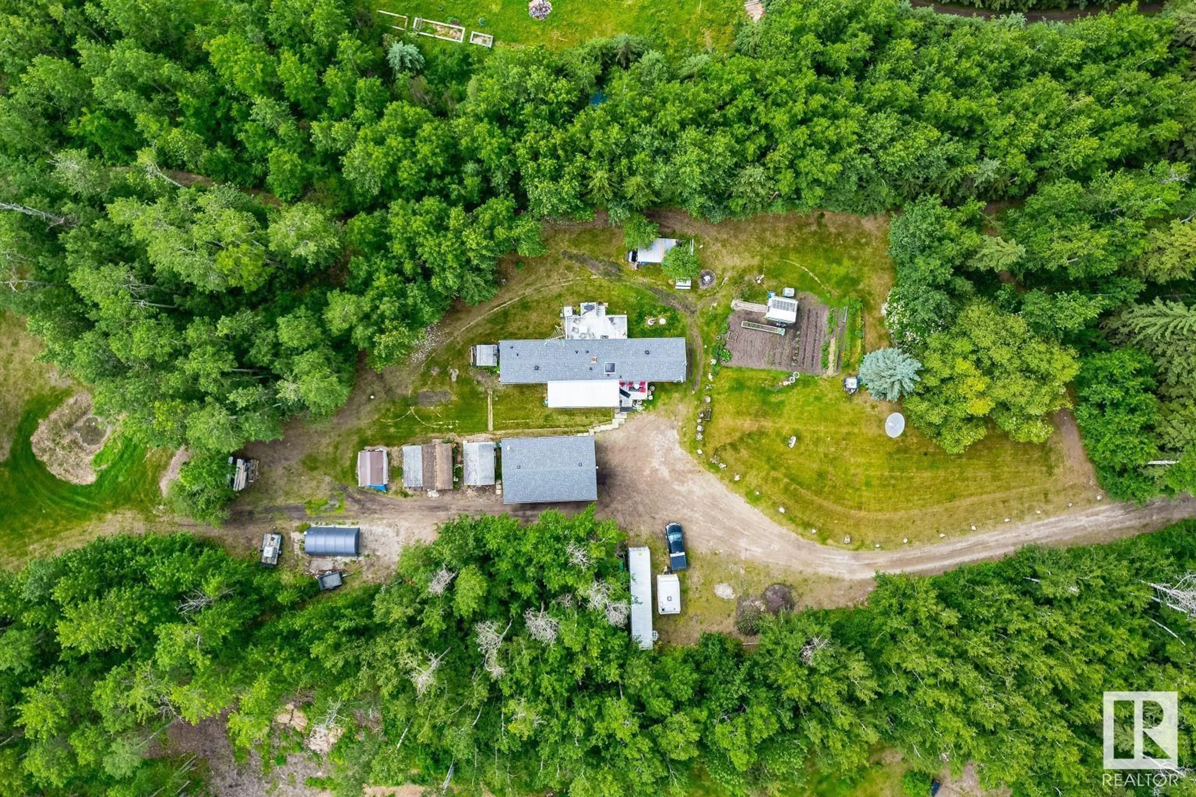 A pic from outside/outdoor area/front of a property/back of a property/a pic from drone, forest/trees view for 54104 - 29 RGE ROAD 35, Rural Lac Ste. Anne County Alberta T0E0A1