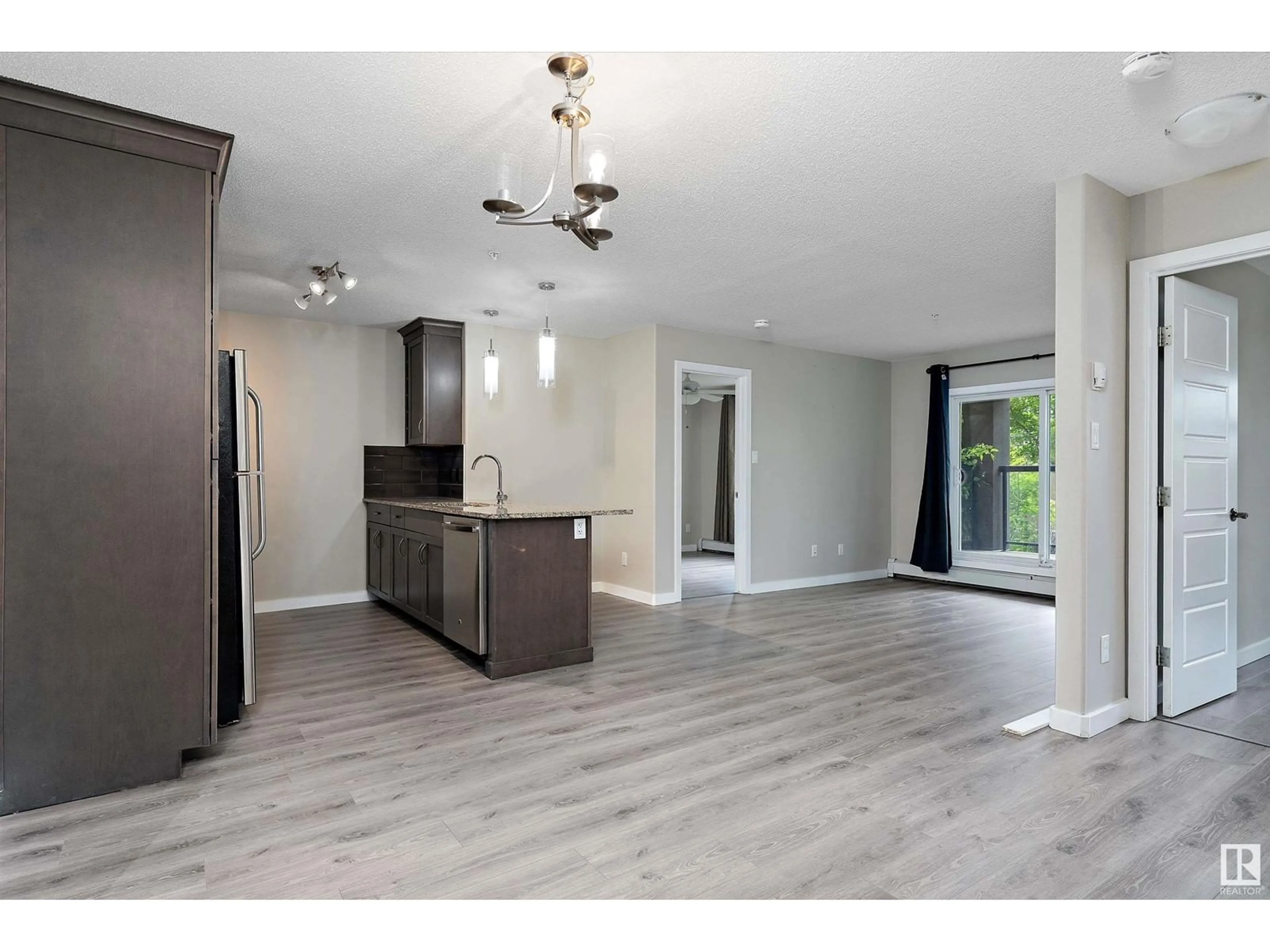 Open concept kitchen, wood/laminate floor for #153 - 7805 71 ST, Edmonton Alberta T6B3V6