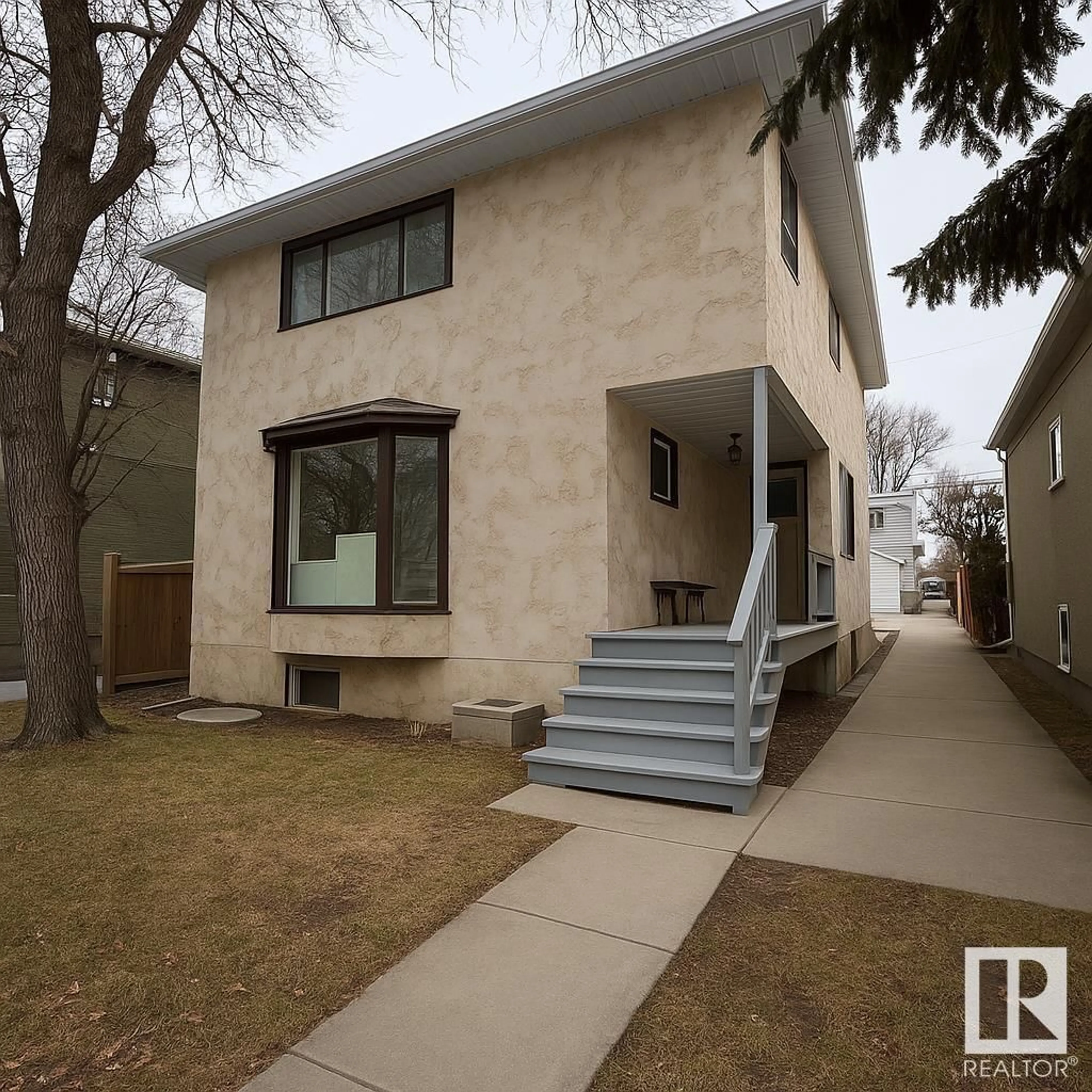 Home with vinyl exterior material, street for 10934 76 AV, Edmonton Alberta T6G0J7
