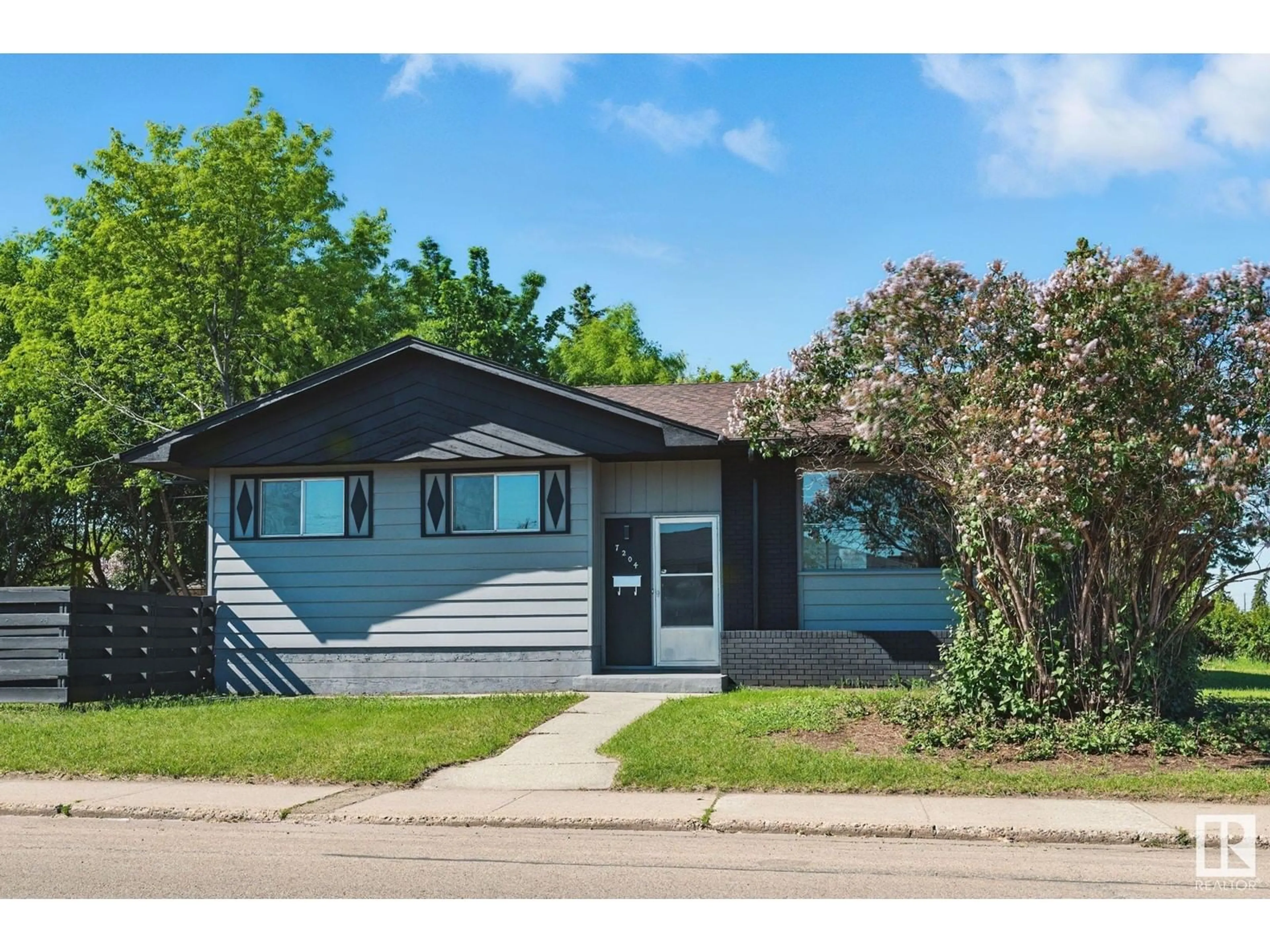 Home with vinyl exterior material, street for 7204 130 AV, Edmonton Alberta T5C1X9