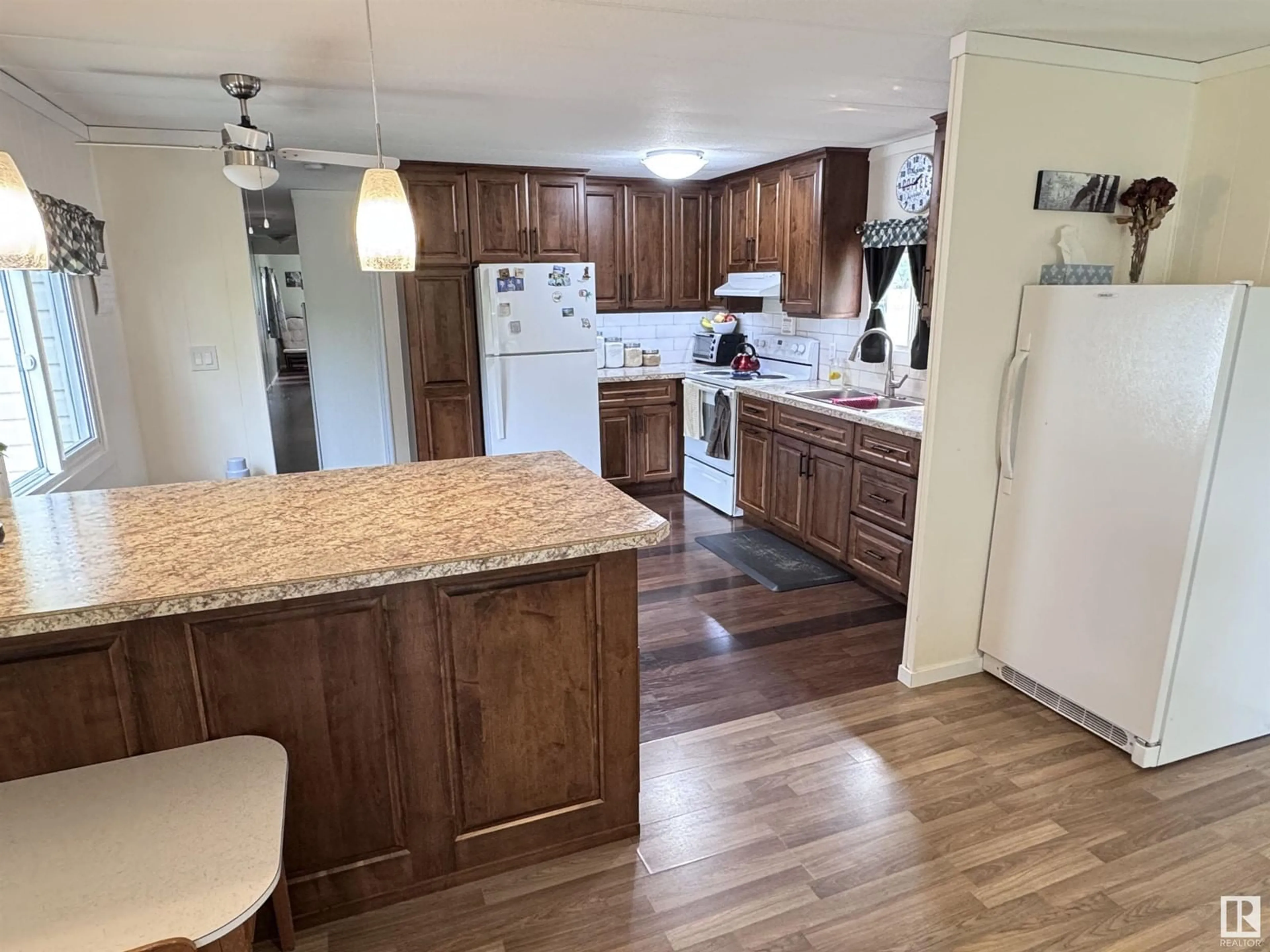 Open concept kitchen, wood/laminate floor for 10003 110 ST, Westlock Alberta T7P1N6