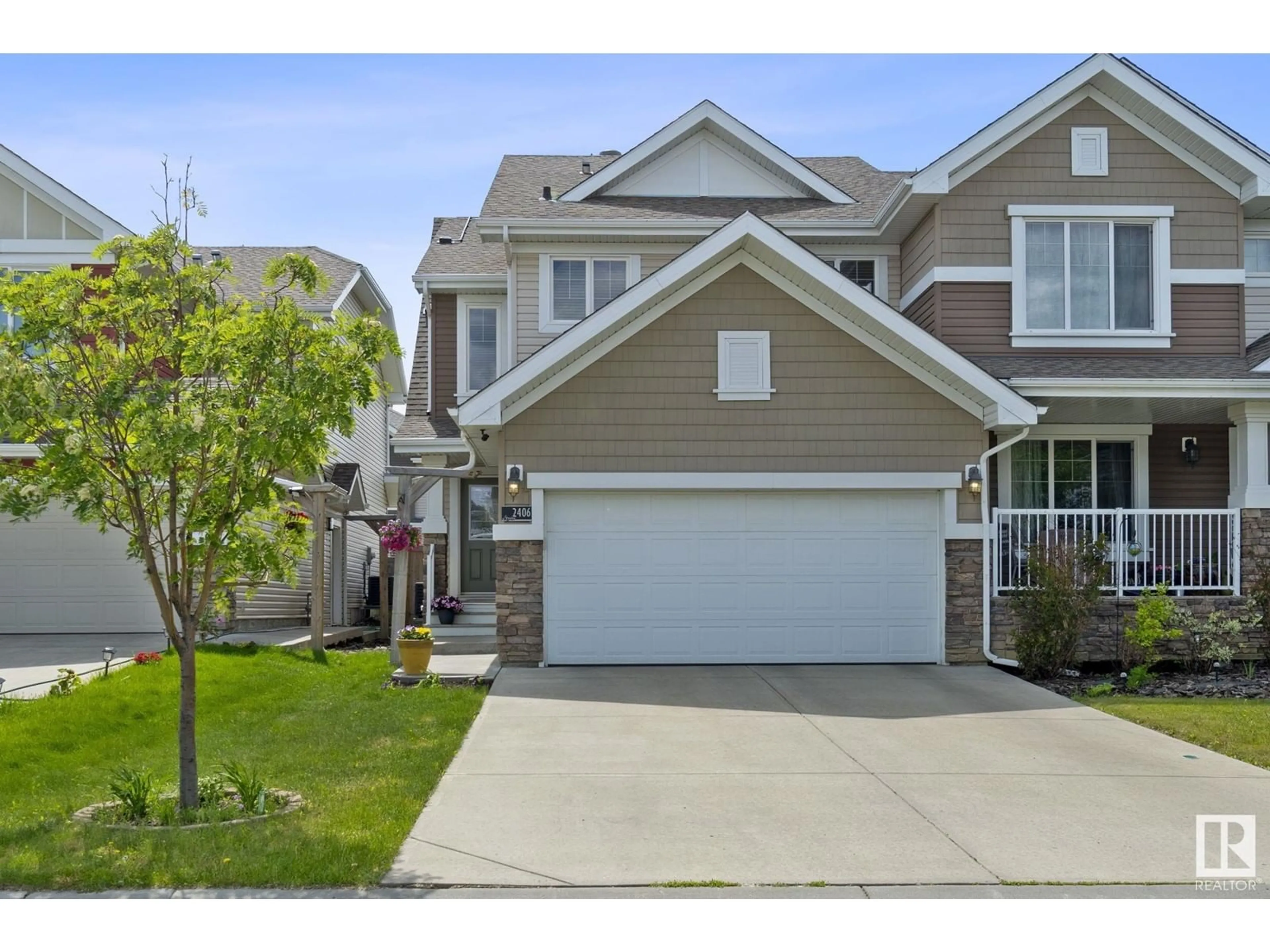 Home with vinyl exterior material, street for 2406 SPARROW CR, Edmonton Alberta T5S0G5