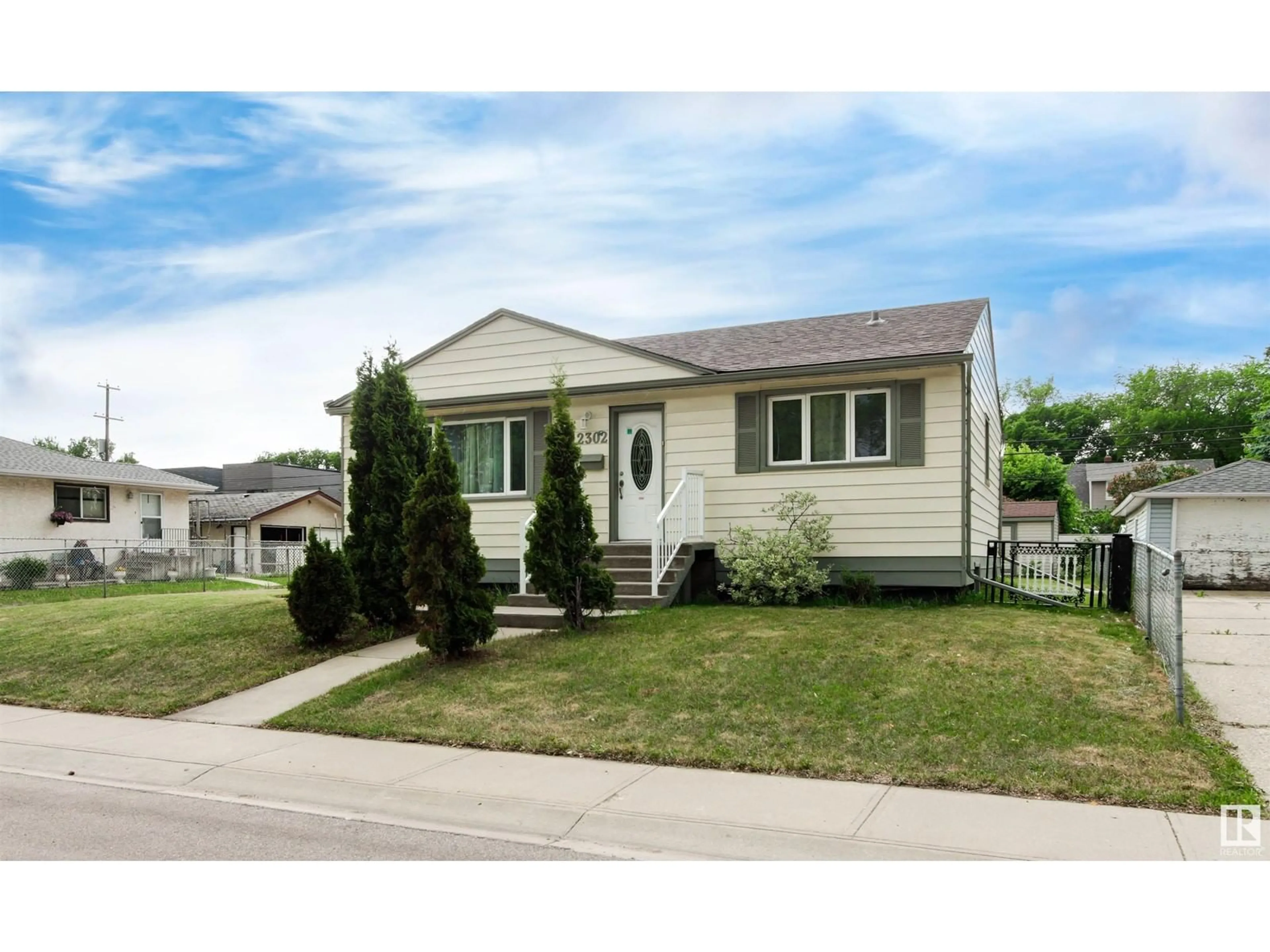 Home with vinyl exterior material, street for 12302 127 ST, Edmonton Alberta T5L0Z8