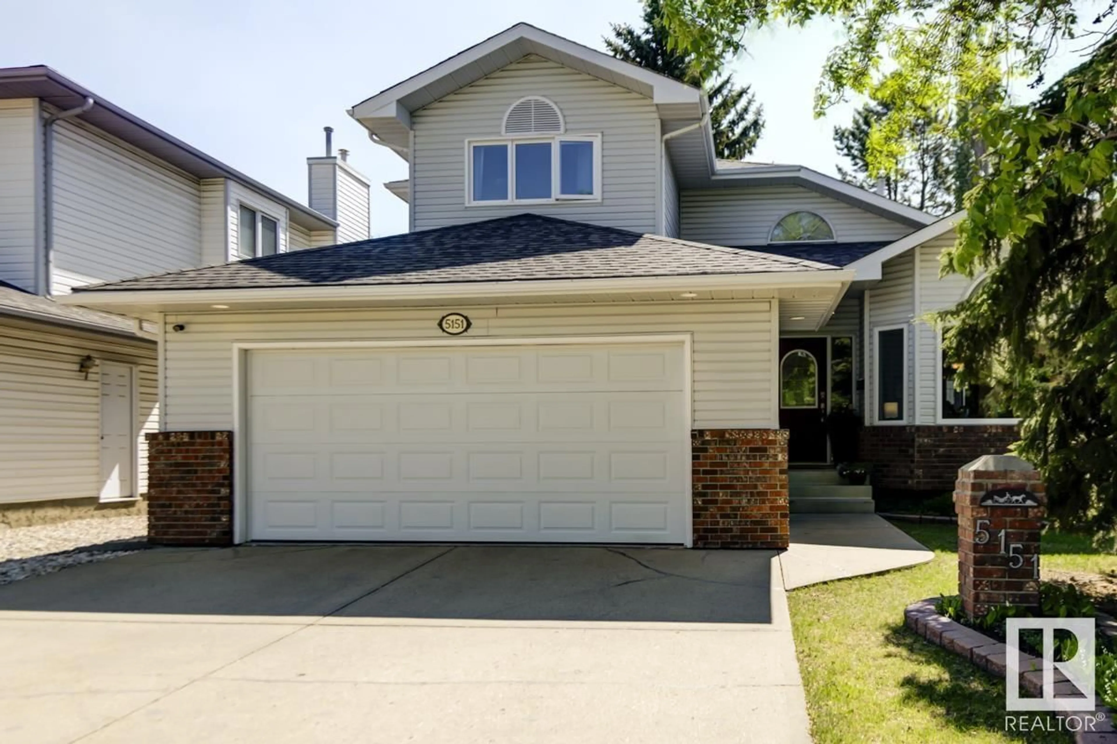 Home with vinyl exterior material, street for 5151 189 ST, Edmonton Alberta T6M2L1