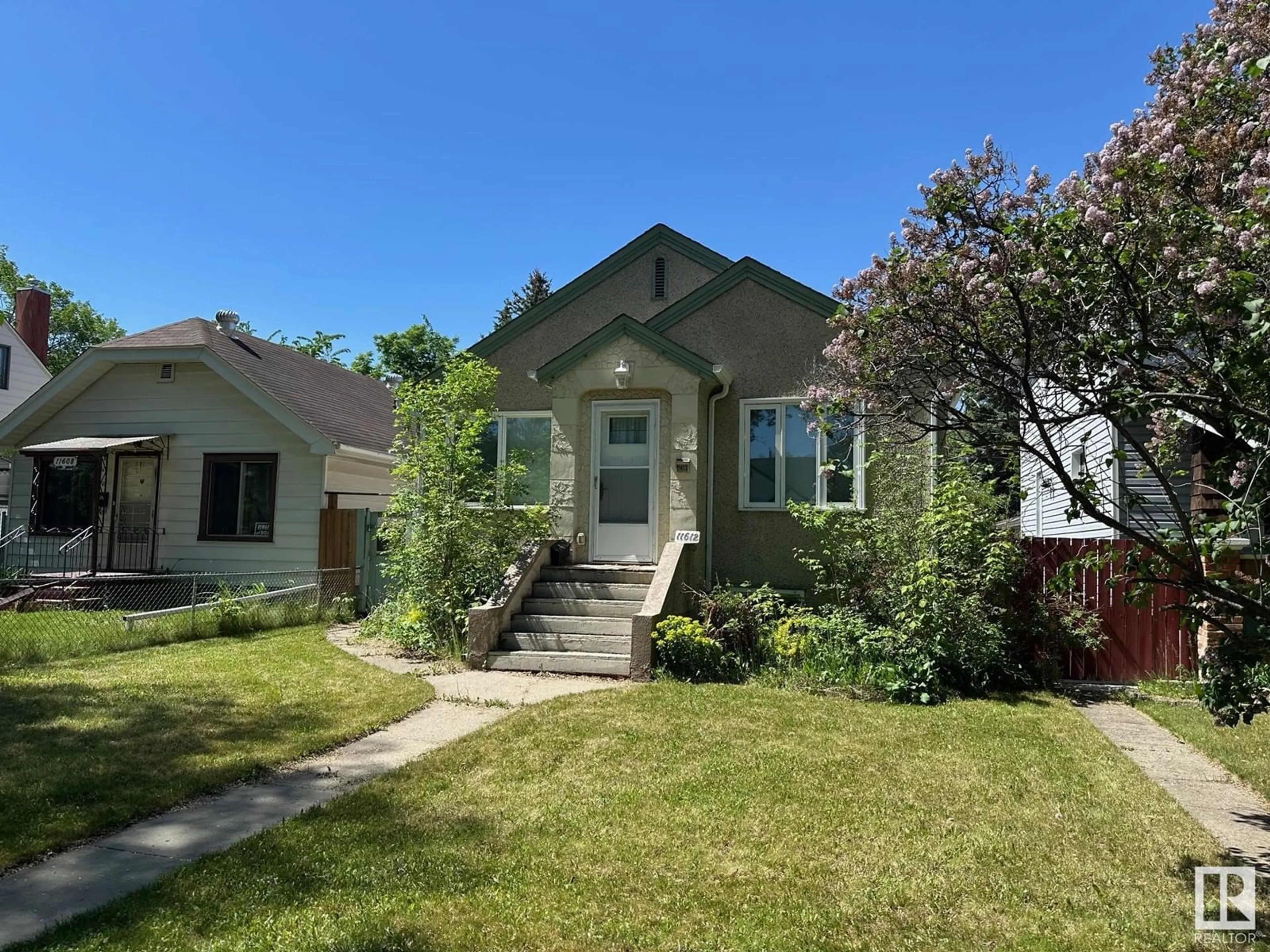 Home with vinyl exterior material, street for NW - 11612 88 ST, Edmonton Alberta T6H4S1