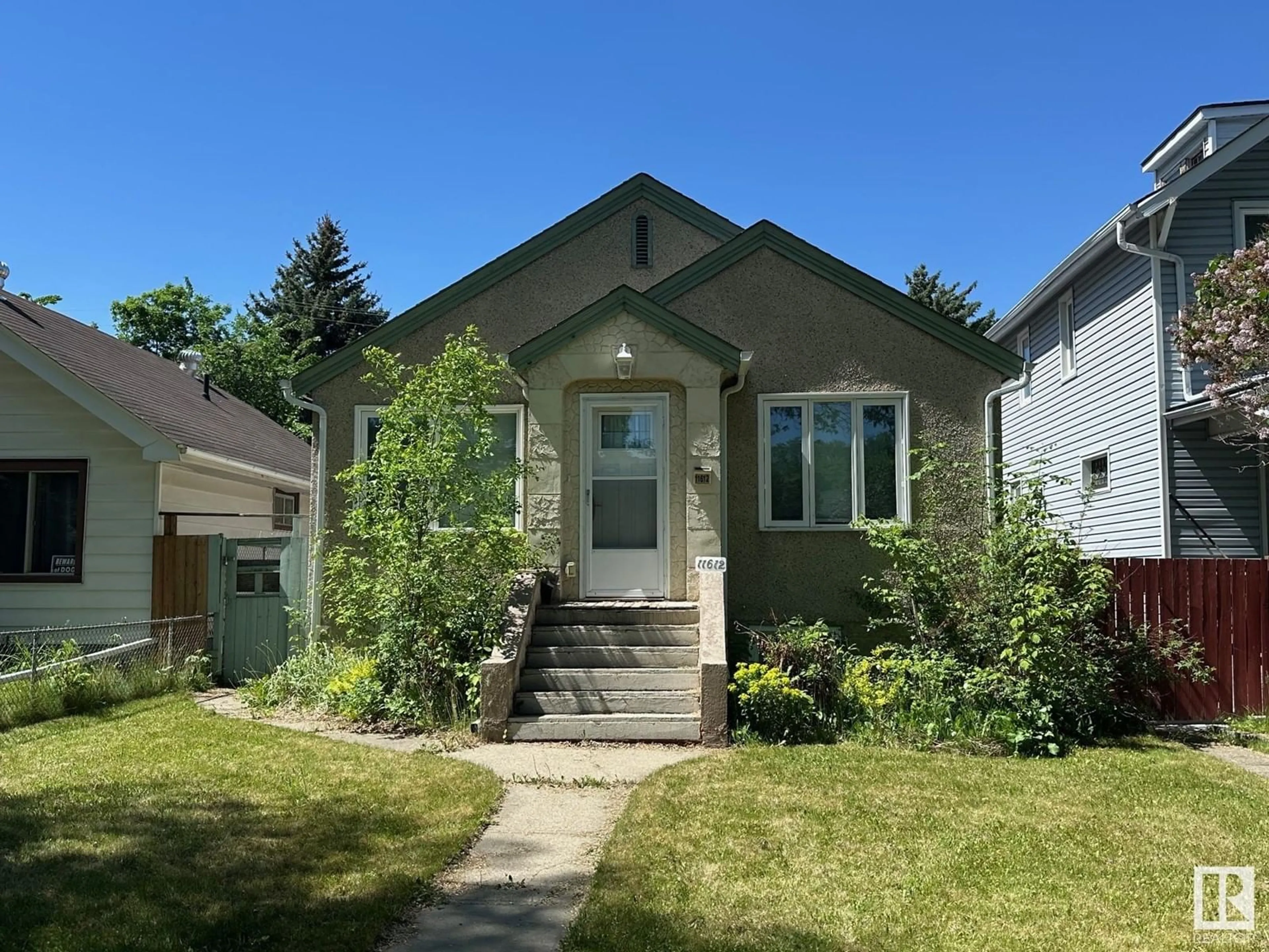 Home with vinyl exterior material, street for NW - 11612 88 ST, Edmonton Alberta T6H4S1