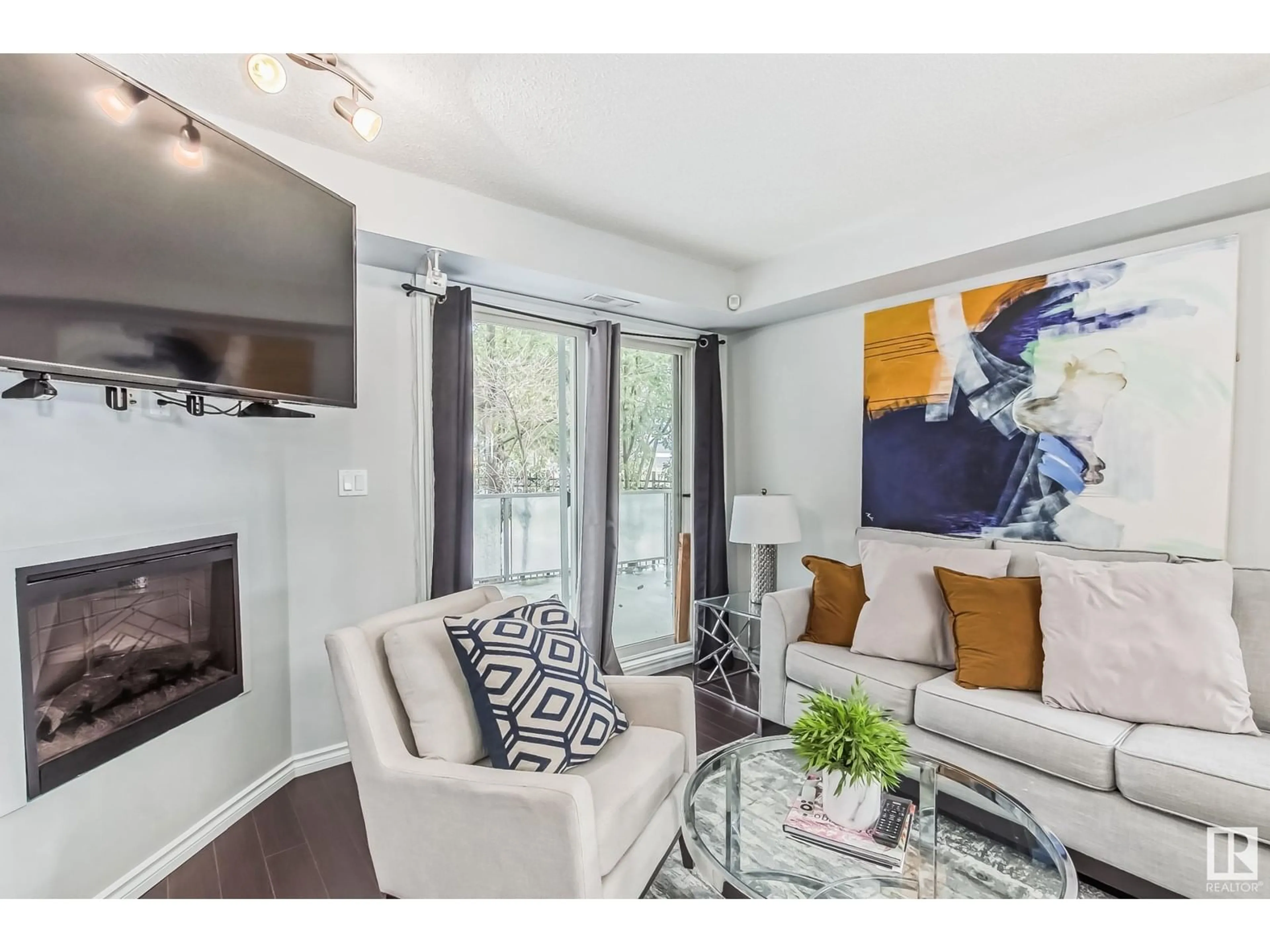 Living room with furniture, unknown for 115 10118 106 AVE NW, Edmonton Alberta T5H0B8