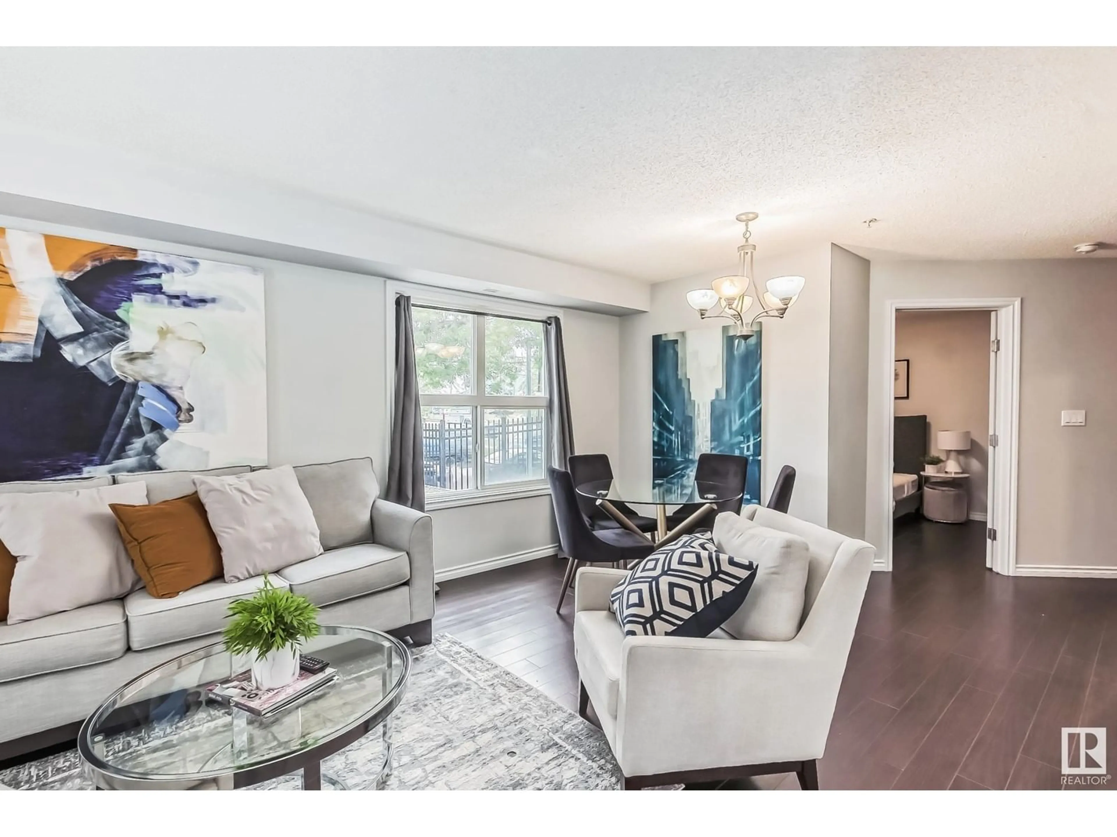 Living room with furniture, wood/laminate floor for 115 10118 106 AVE NW, Edmonton Alberta T5H0B8