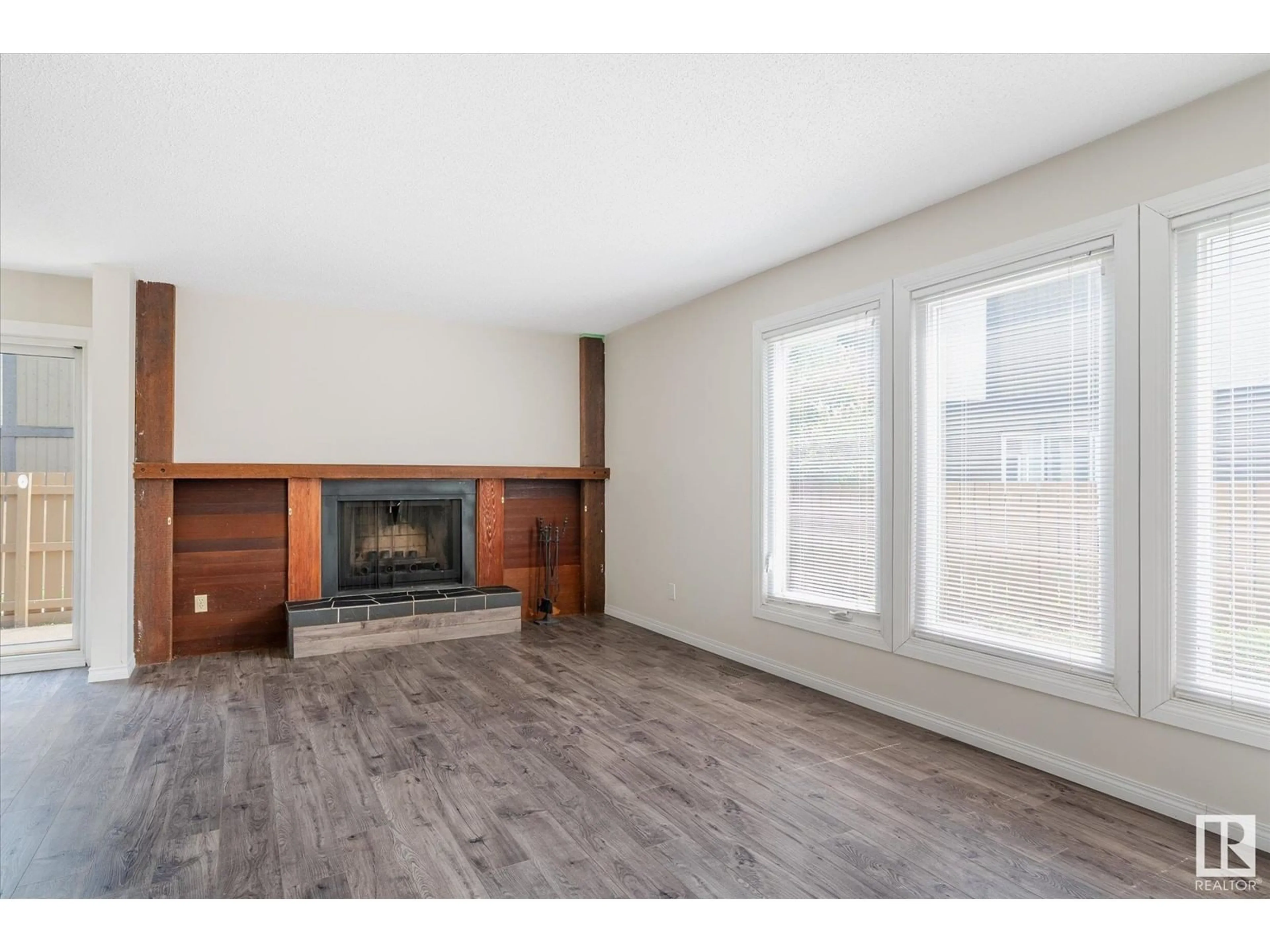 Living room with furniture, wood/laminate floor for 7061 32 AV, Edmonton Alberta T6K2K9