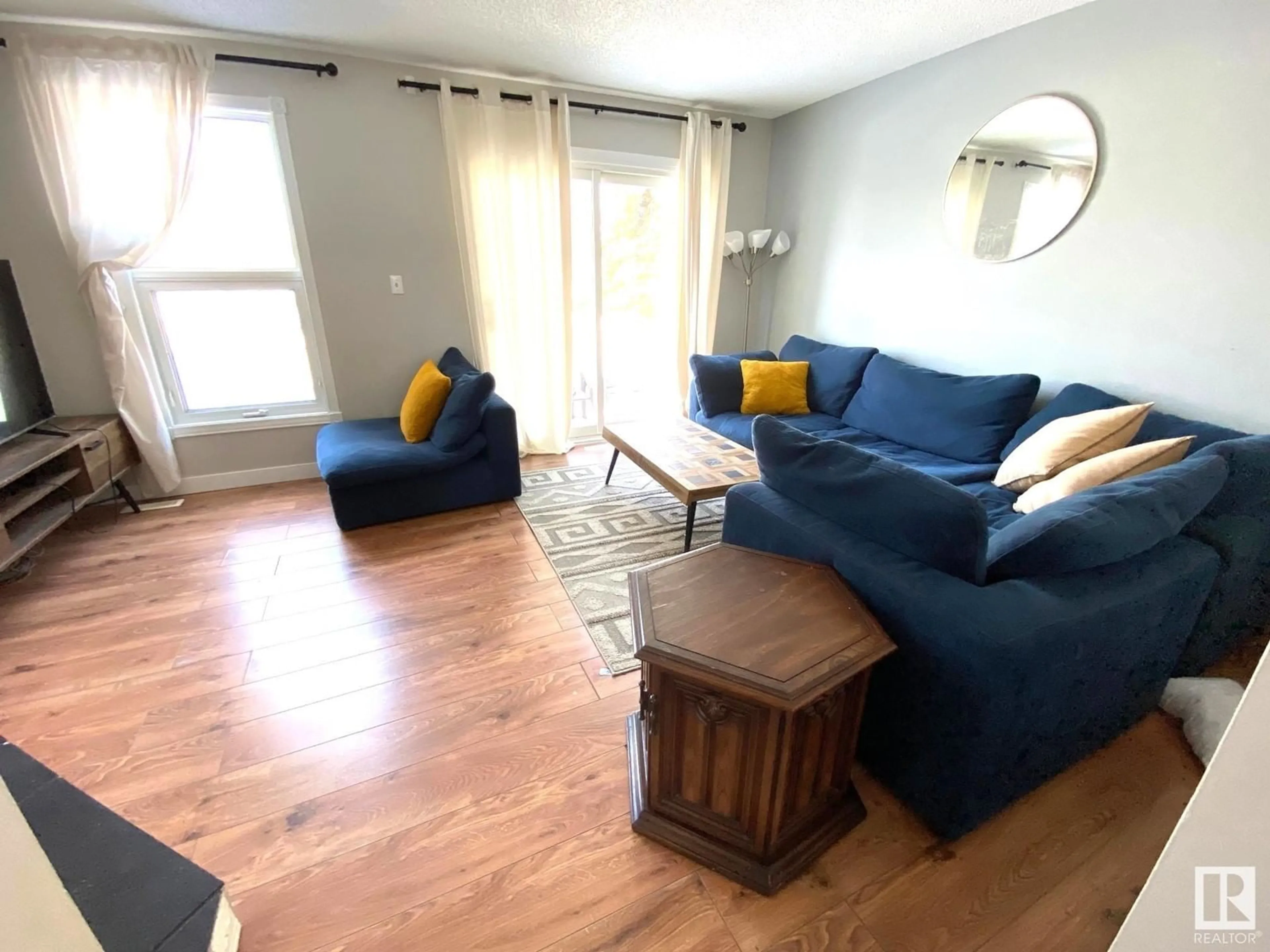 Living room with furniture, wood/laminate floor for 10480 28A AV, Edmonton Alberta T6J4J6