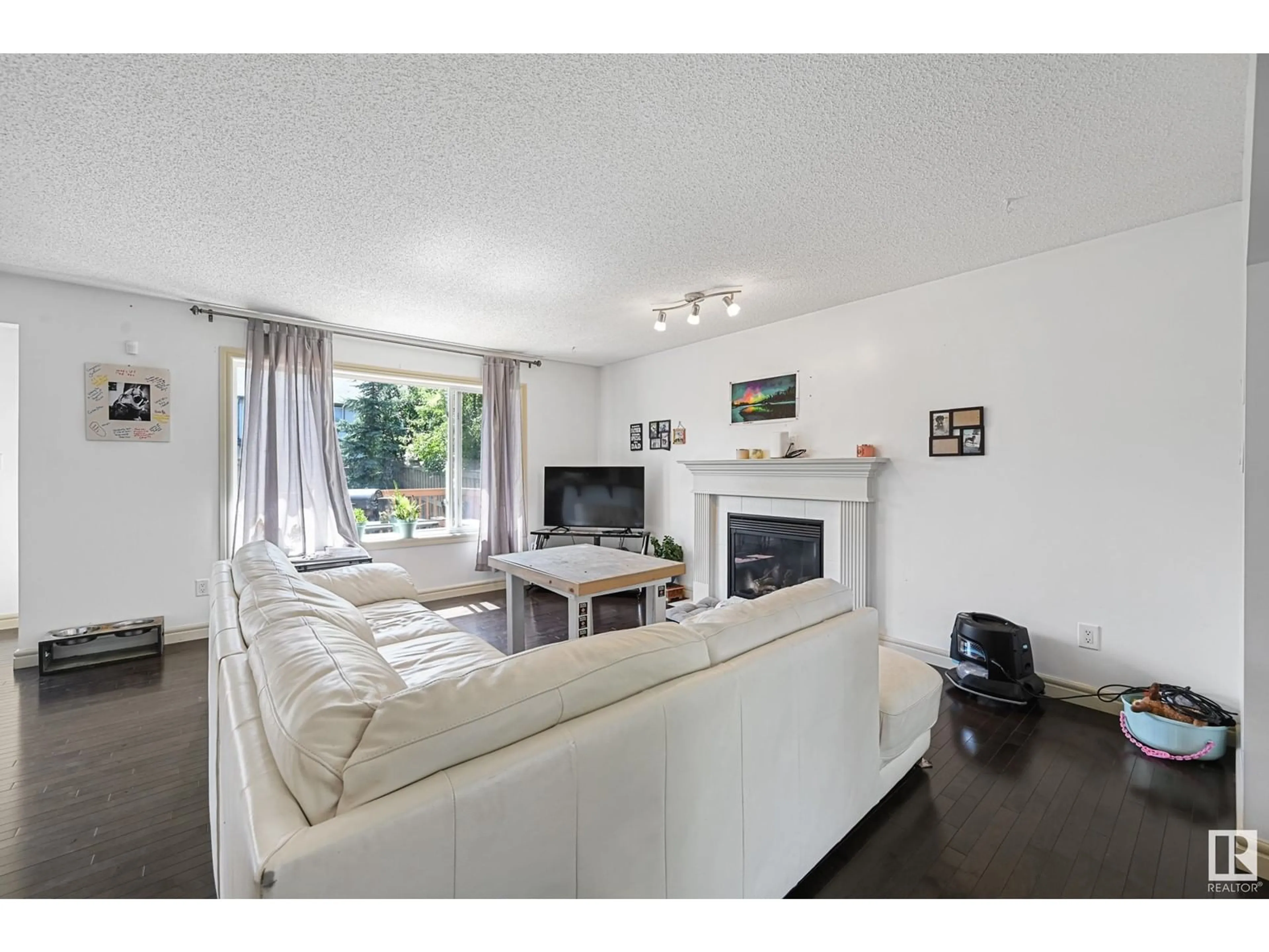 Living room with furniture, wood/laminate floor for 8411 SLOANE CR, Edmonton Alberta T6R0L4