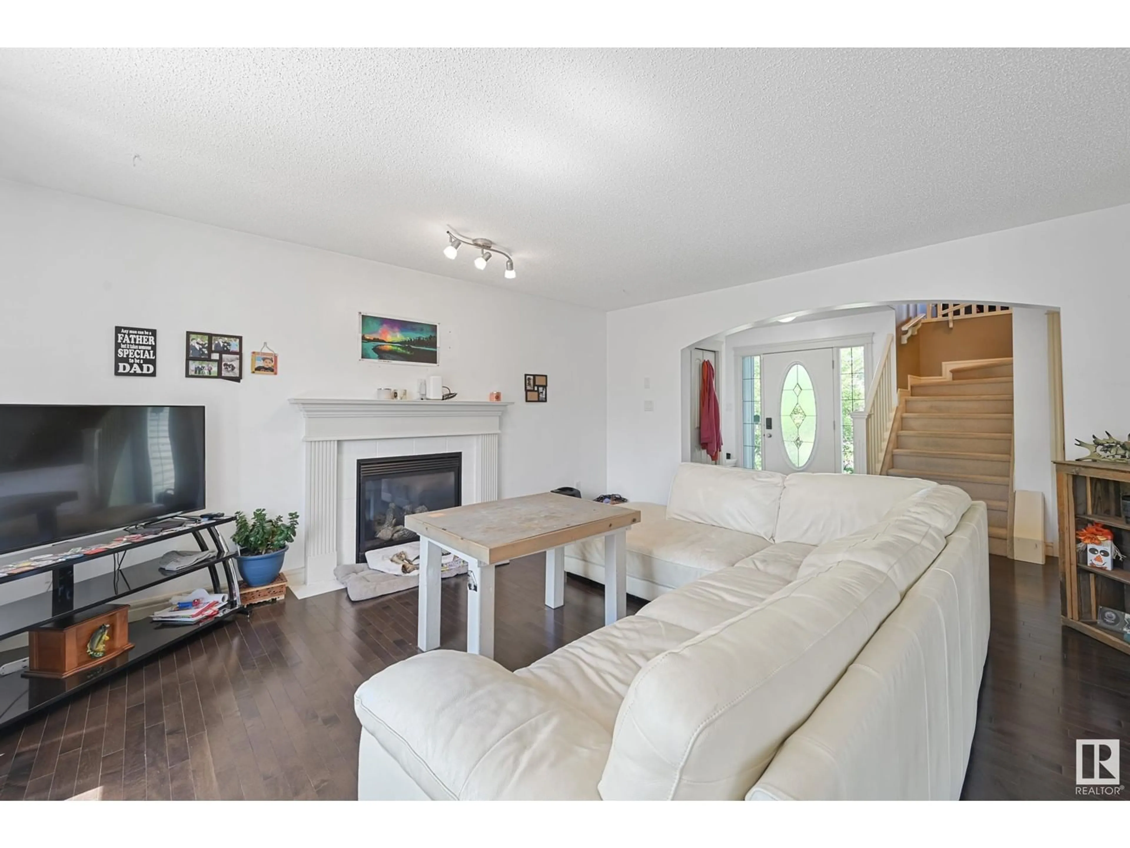 Living room with furniture, wood/laminate floor for 8411 SLOANE CR, Edmonton Alberta T6R0L4