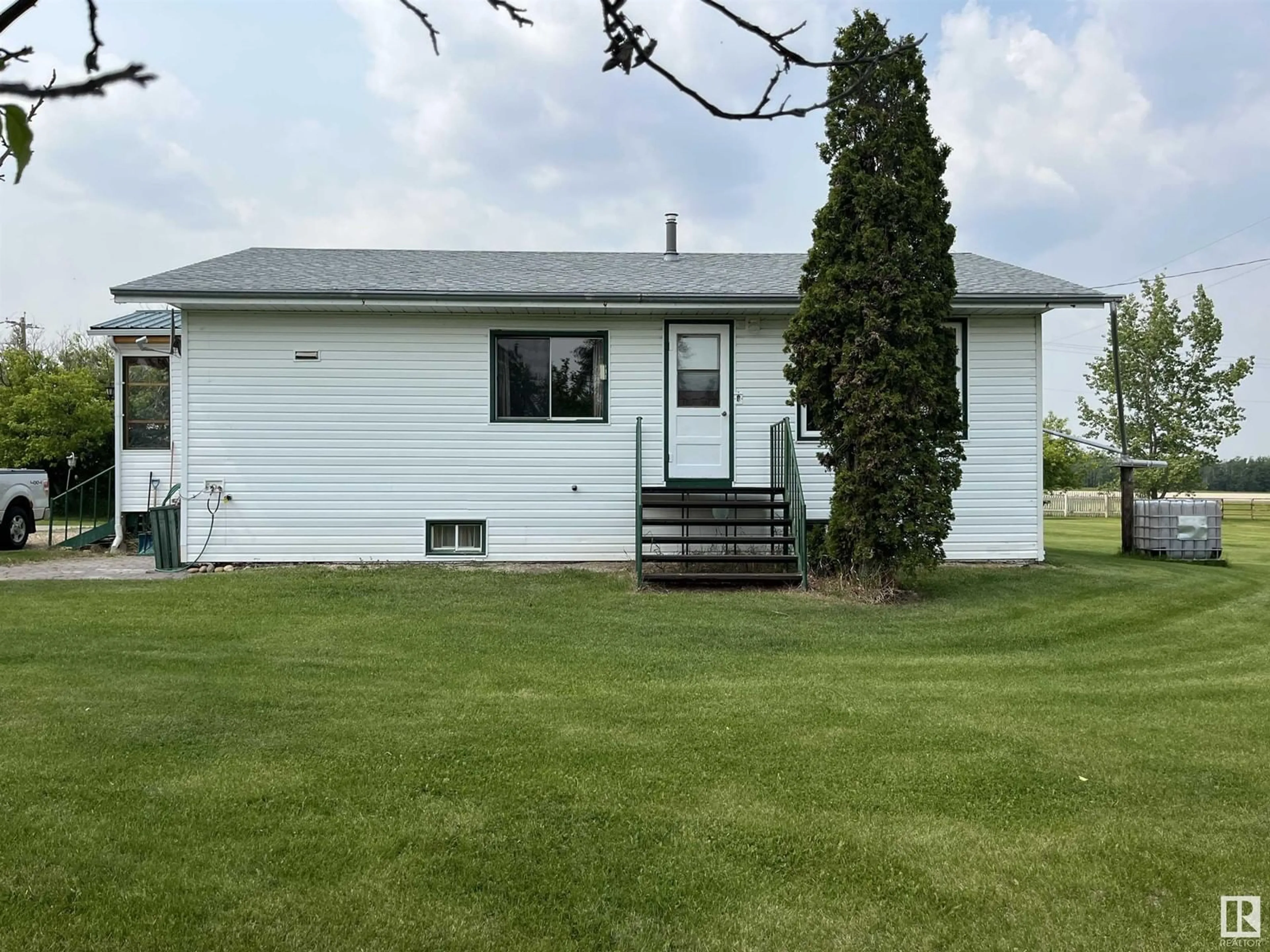 Home with vinyl exterior material, street for #102 - 56227 HWY 33, Rural Lac Ste. Anne County Alberta T0E1A0