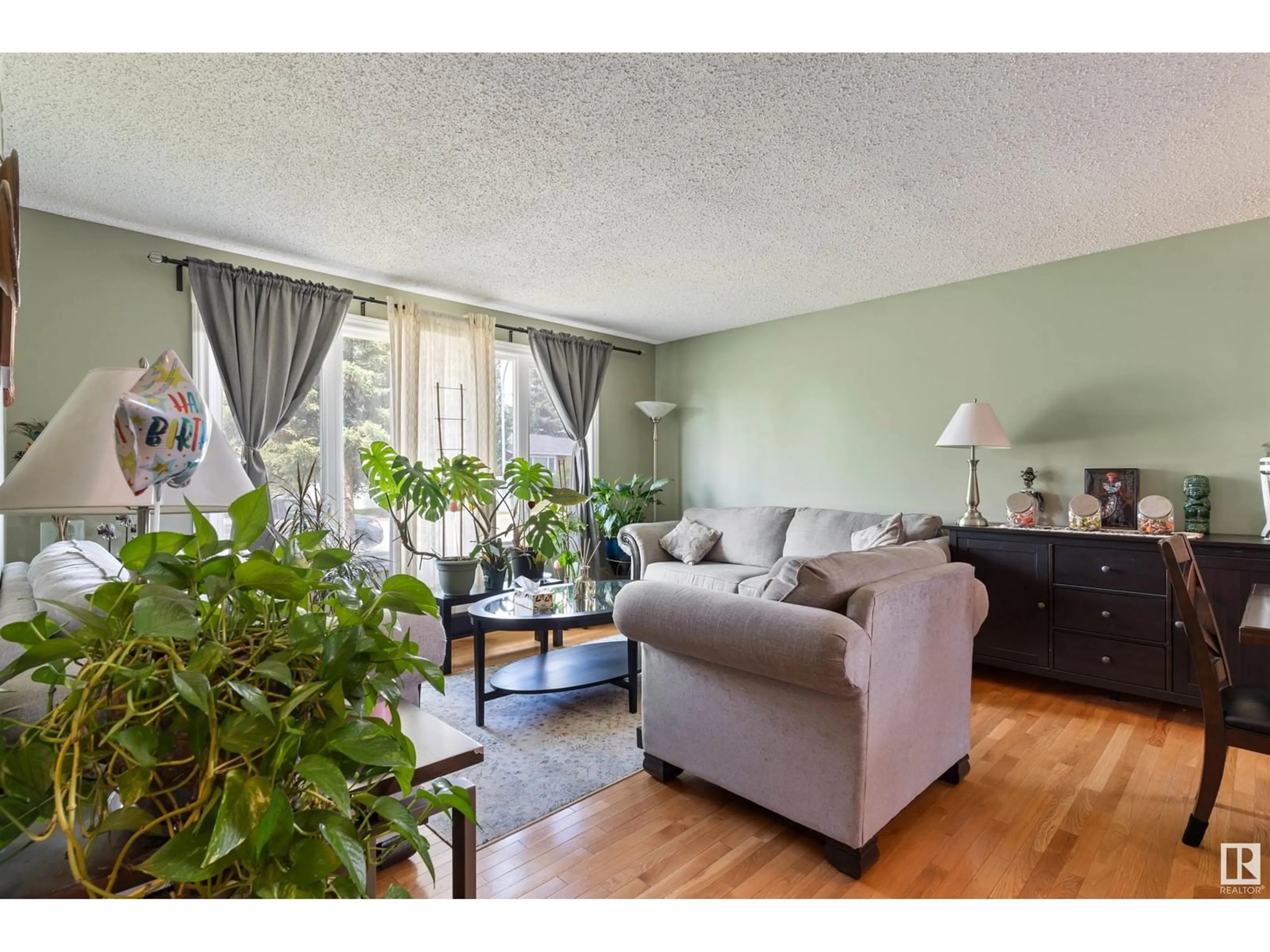 Living room with furniture, wood/laminate floor for 1141 77 ST, Edmonton Alberta T6K3G4
