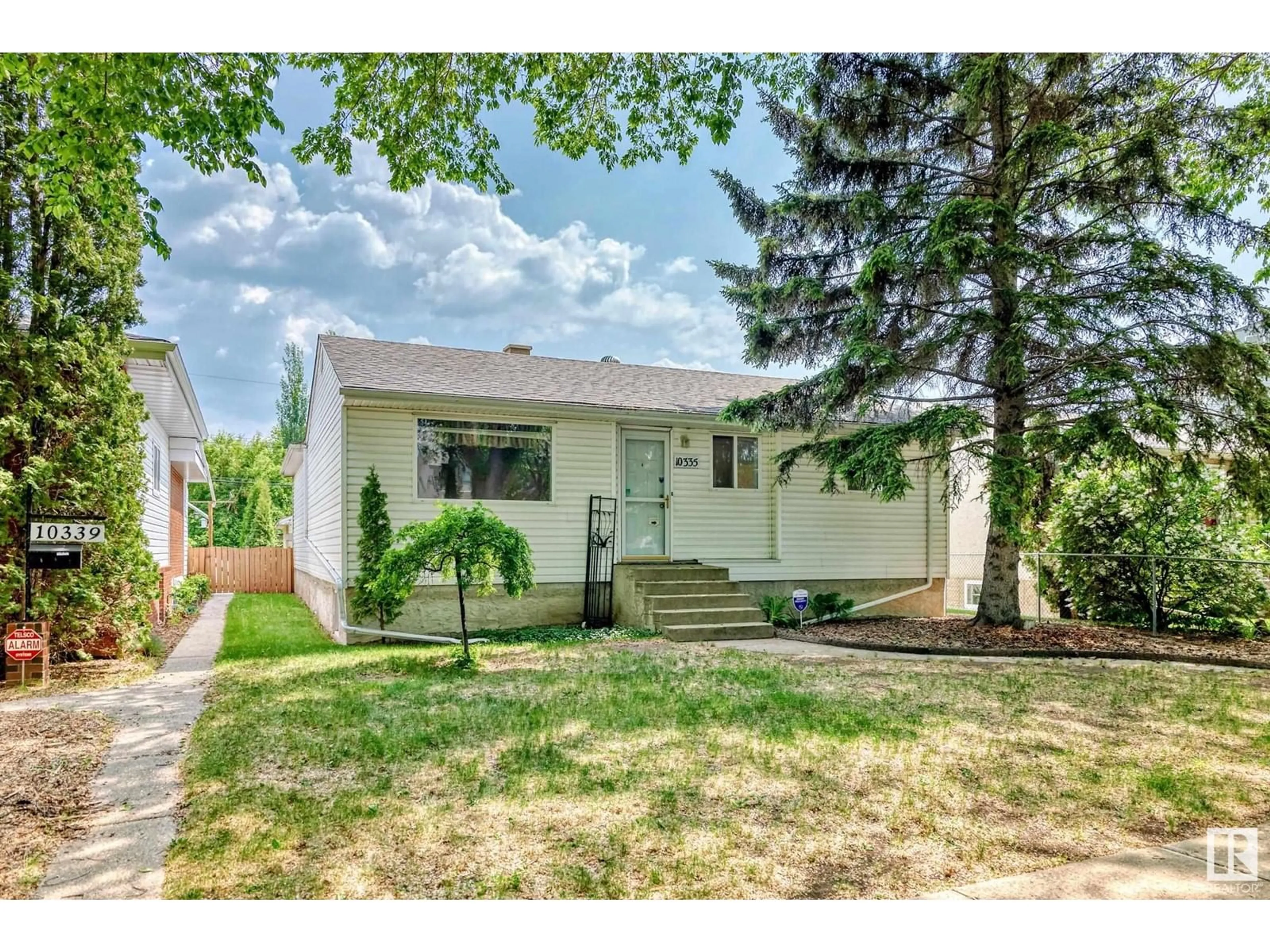 Home with vinyl exterior material, street for NW - 10335 83 ST, Edmonton Alberta T6A3N9