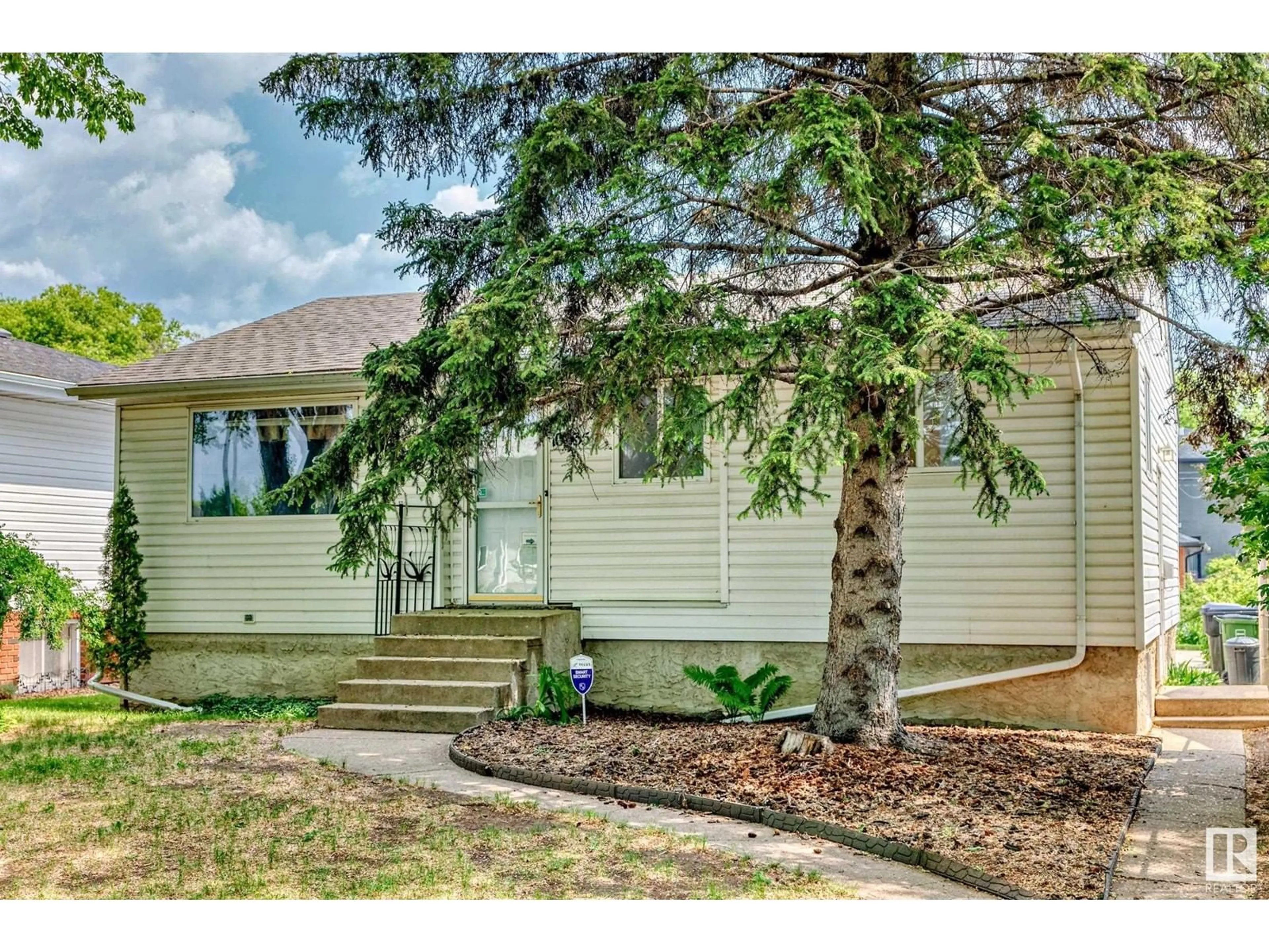 Home with vinyl exterior material, street for NW - 10335 83 ST, Edmonton Alberta T6A3N9