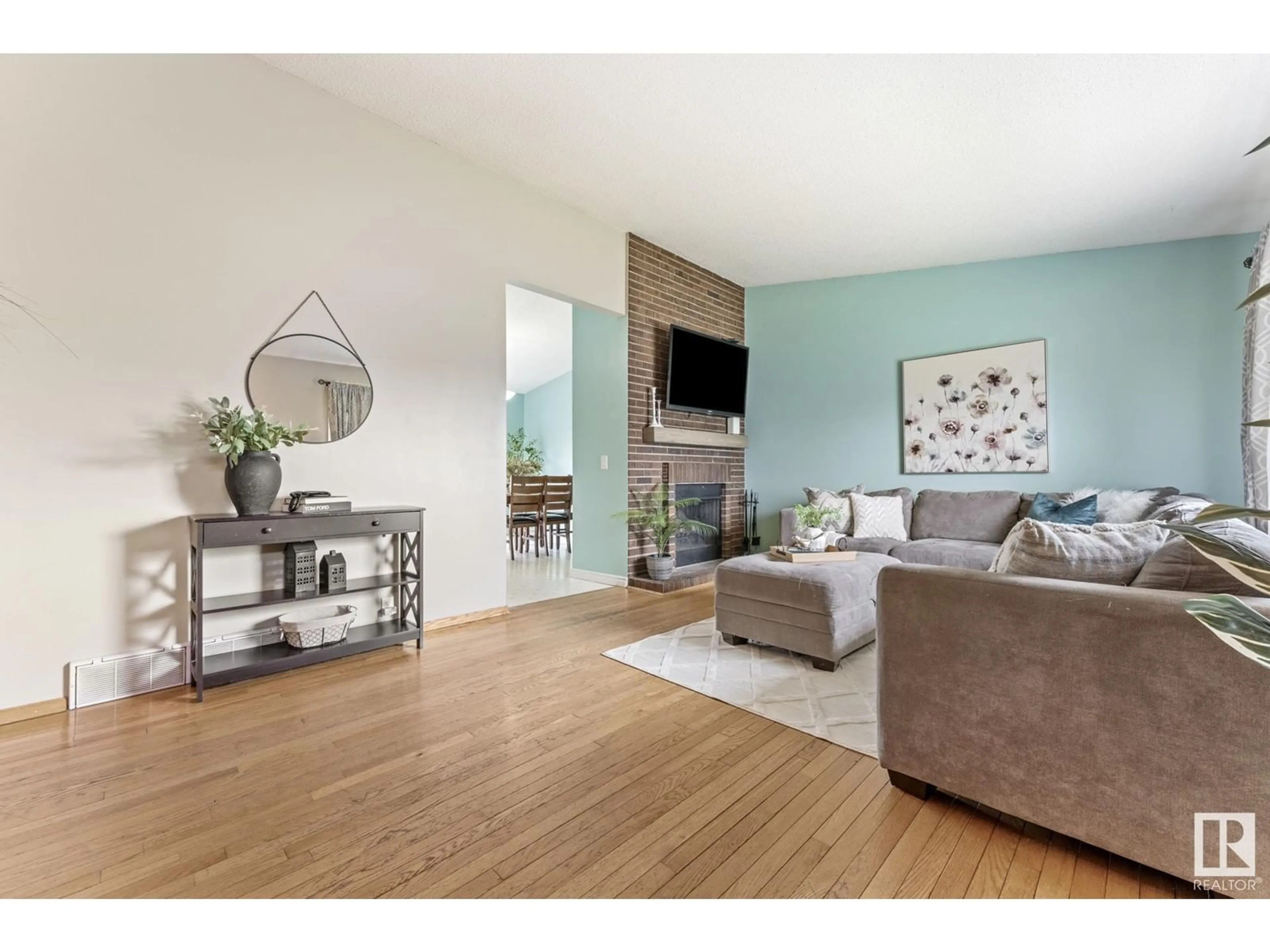 Living room with furniture, wood/laminate floor for 8324 19 AV, Edmonton Alberta T6K2E1