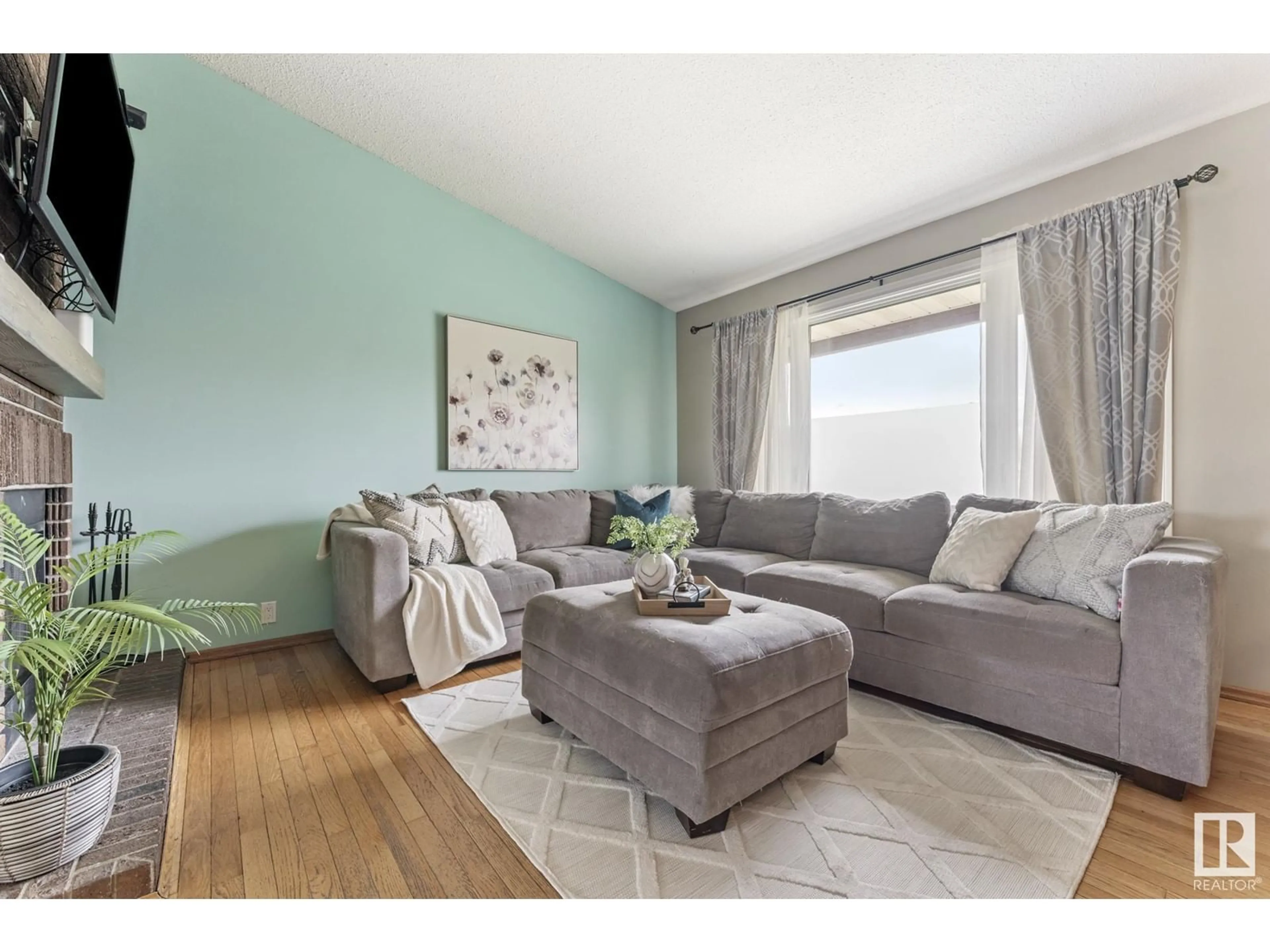 Living room with furniture, wood/laminate floor for 8324 19 AV, Edmonton Alberta T6K2E1