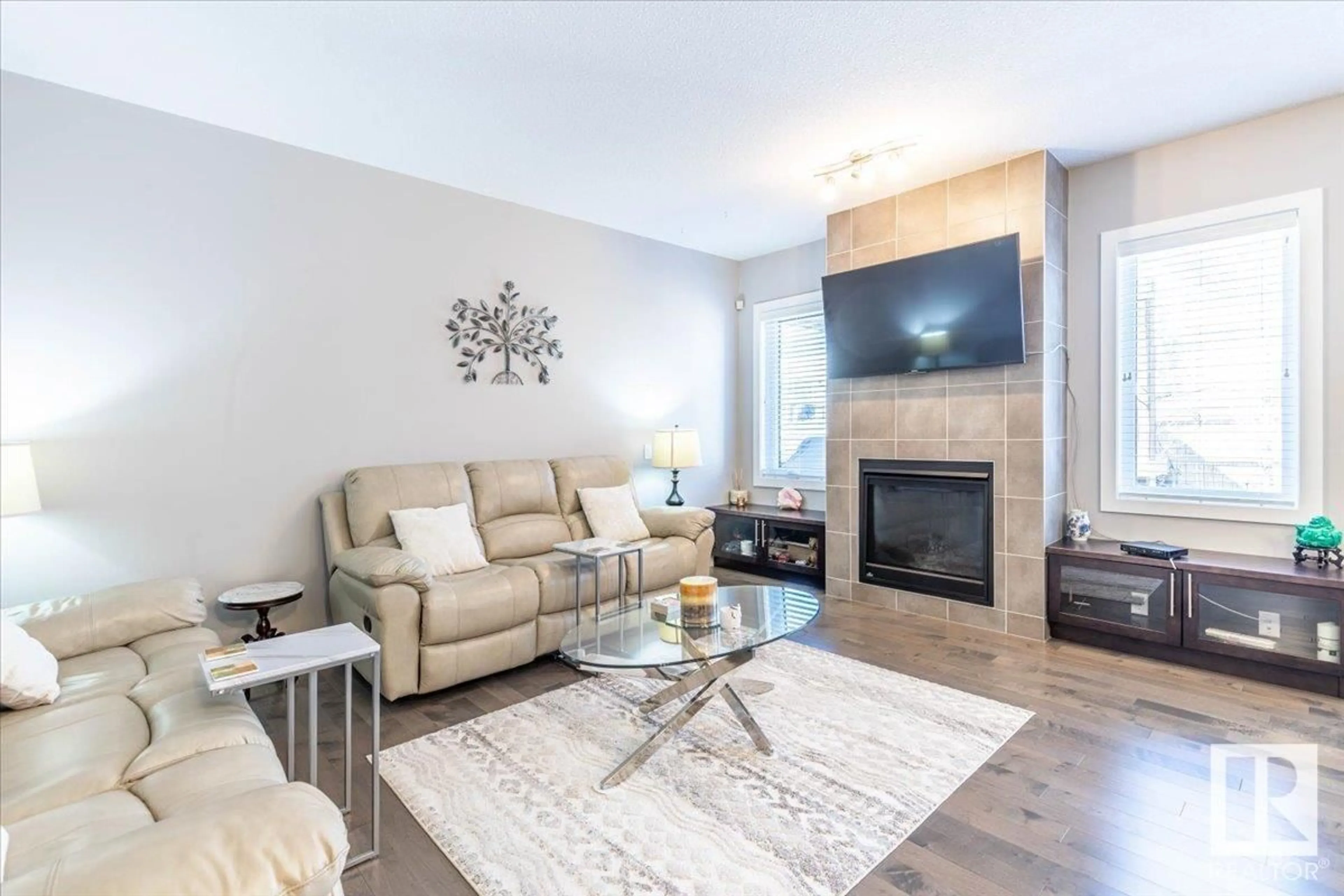Living room with furniture, wood/laminate floor for NW - 7853 ERASMUS WD, Edmonton Alberta T6M0S3