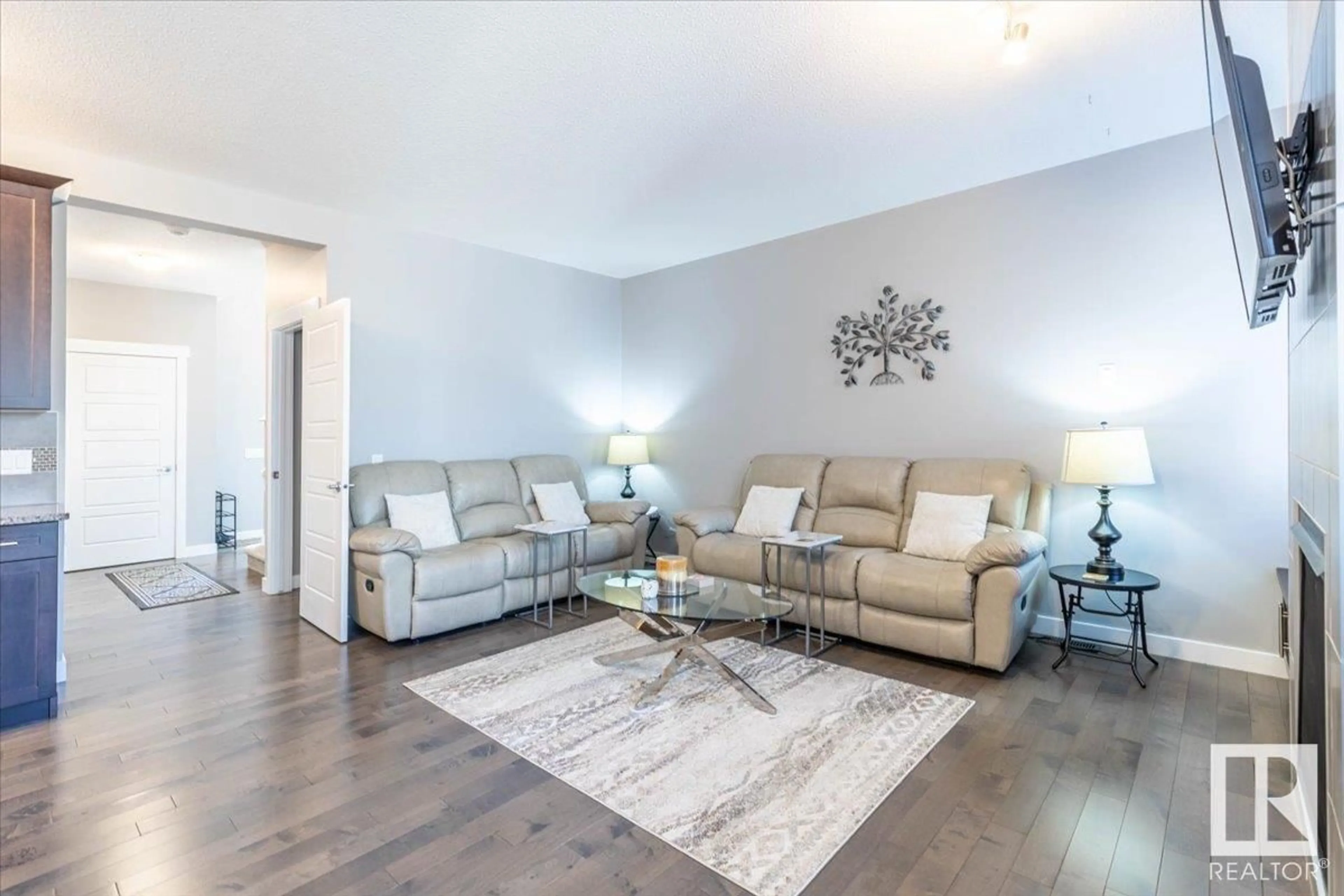 Living room with furniture, wood/laminate floor for NW - 7853 ERASMUS WD, Edmonton Alberta T6M0S3