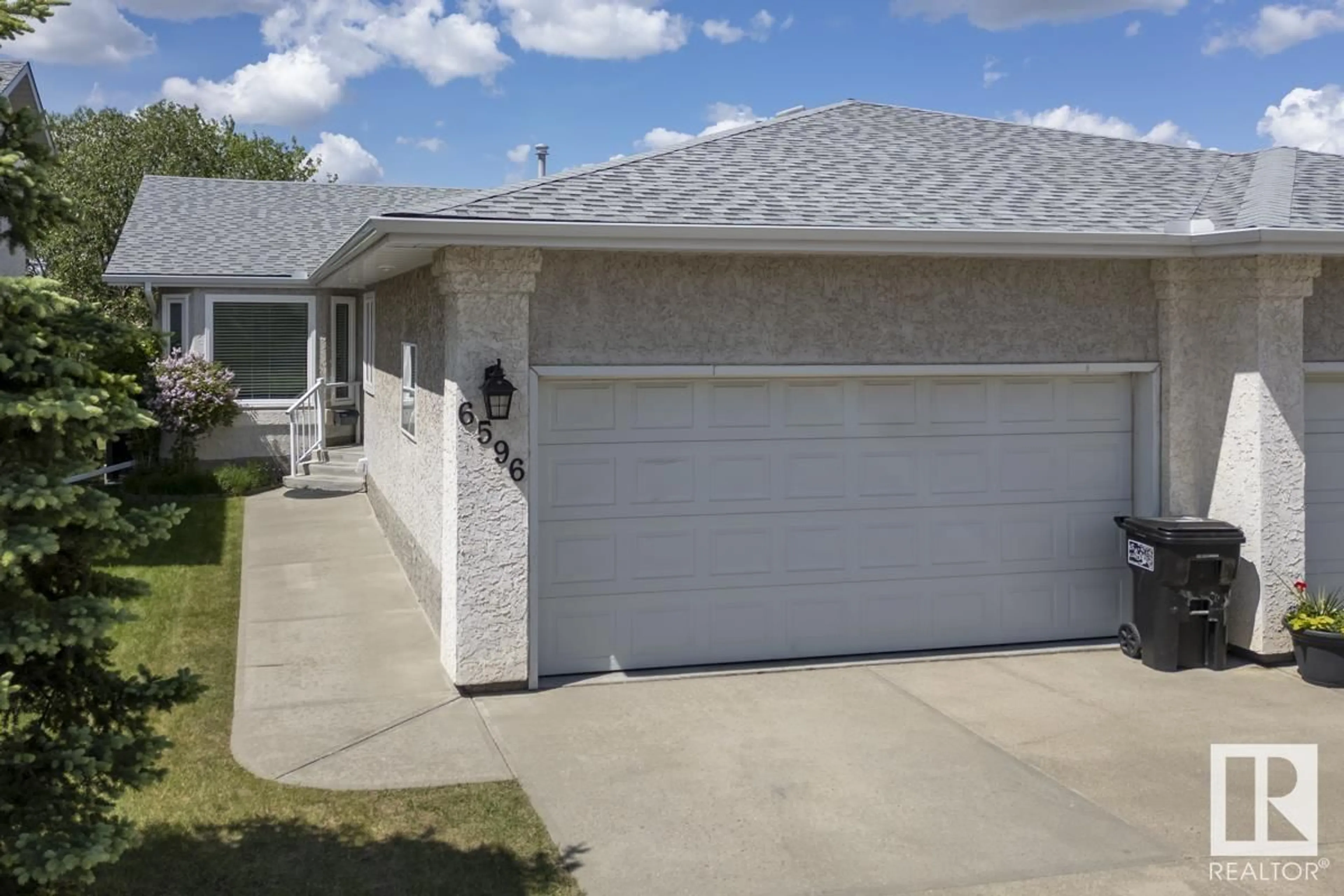 Home with vinyl exterior material, street for NW - 6596 158 AV, Edmonton Alberta T5Y2S7