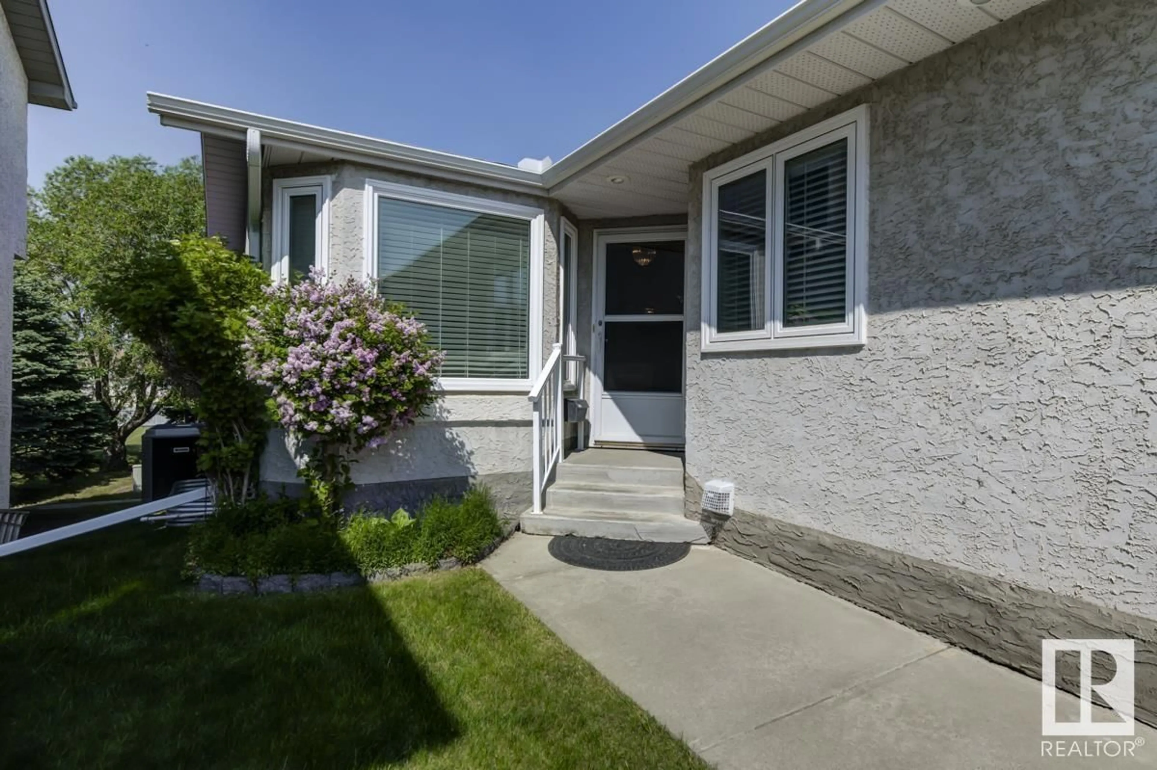 Home with vinyl exterior material, street for NW - 6596 158 AV, Edmonton Alberta T5Y2S7