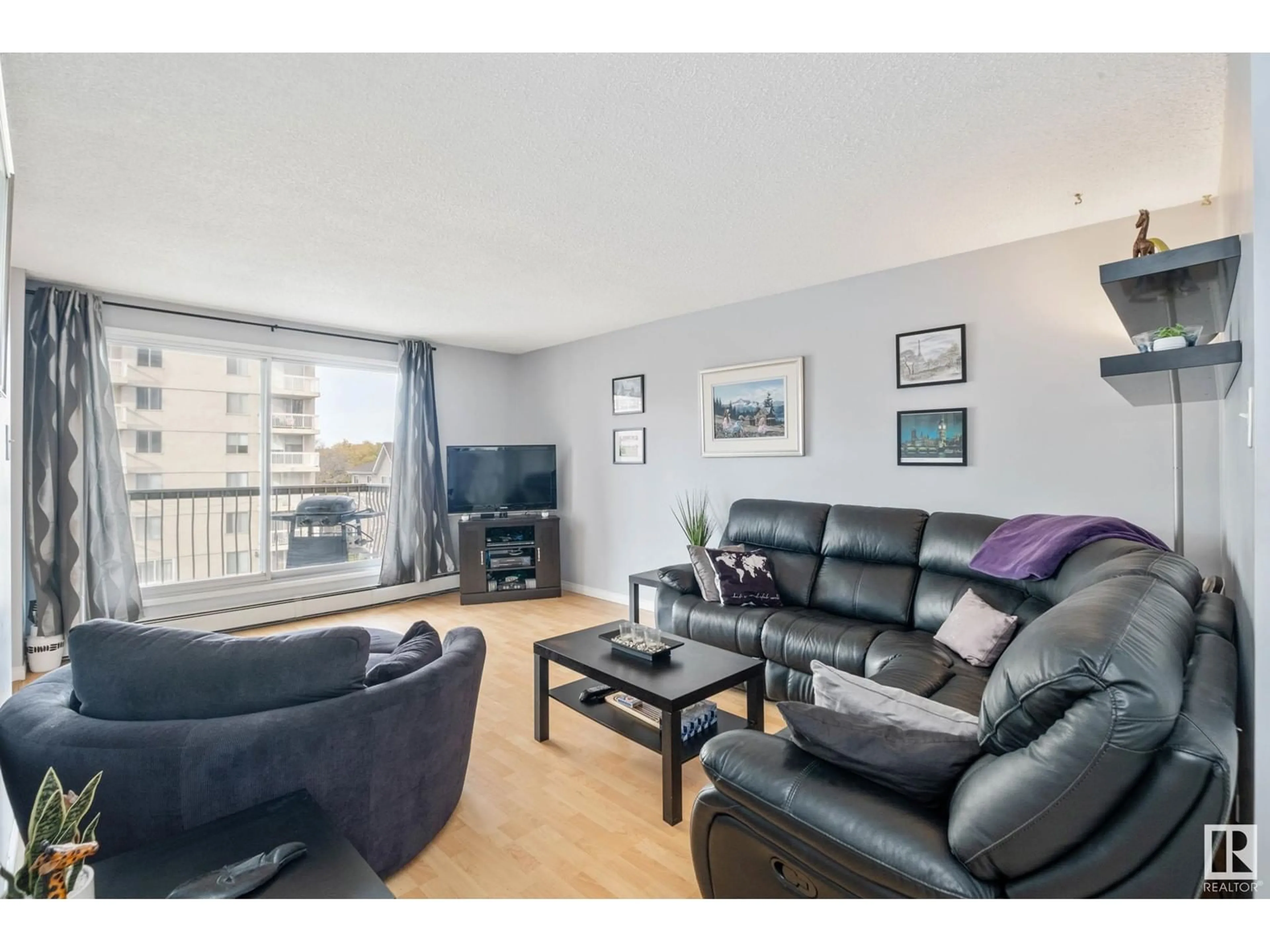 Living room with furniture, wood/laminate floor for 506 - 10150 117 ST, Edmonton Alberta T5K2J2