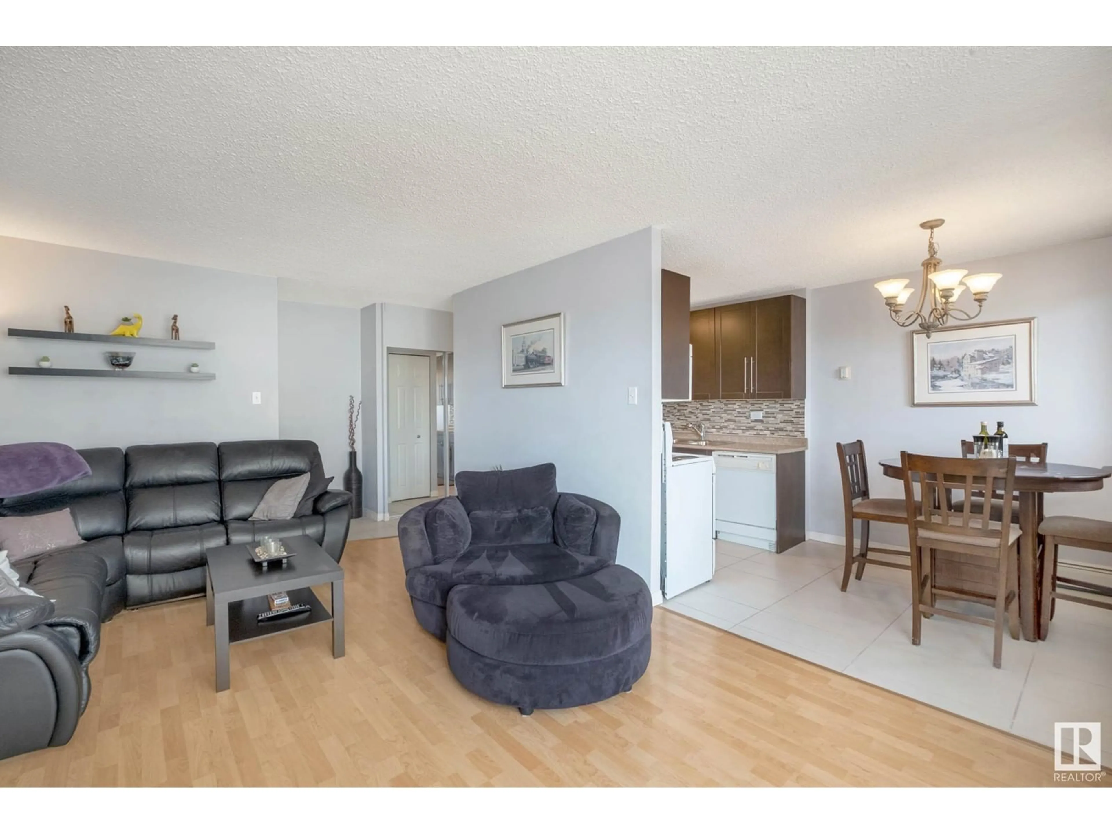 Living room with furniture, wood/laminate floor for 506 - 10150 117 ST, Edmonton Alberta T5K2J2