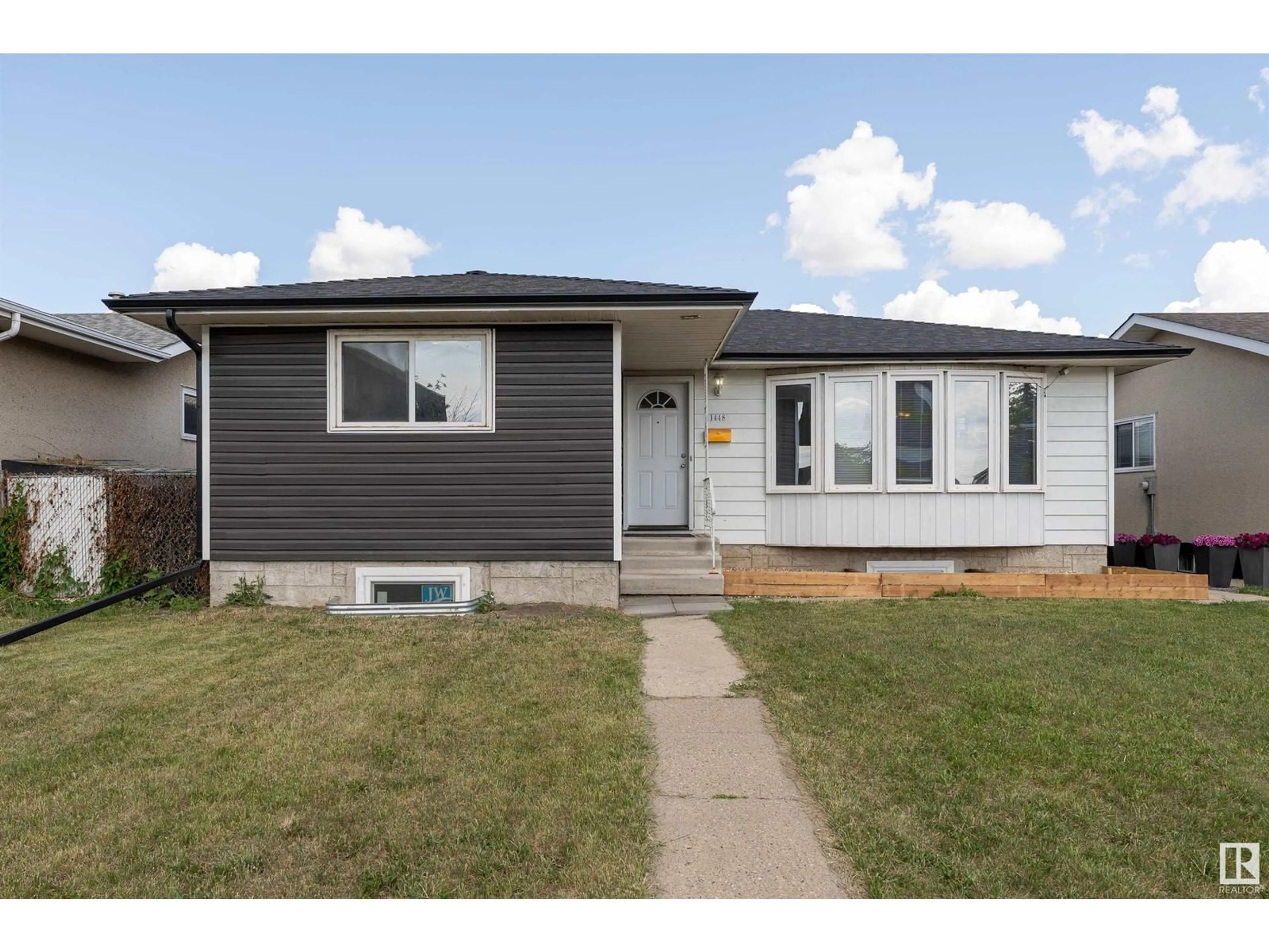 Home with vinyl exterior material, street for 11448 152 AV, Edmonton Alberta T5X1C7