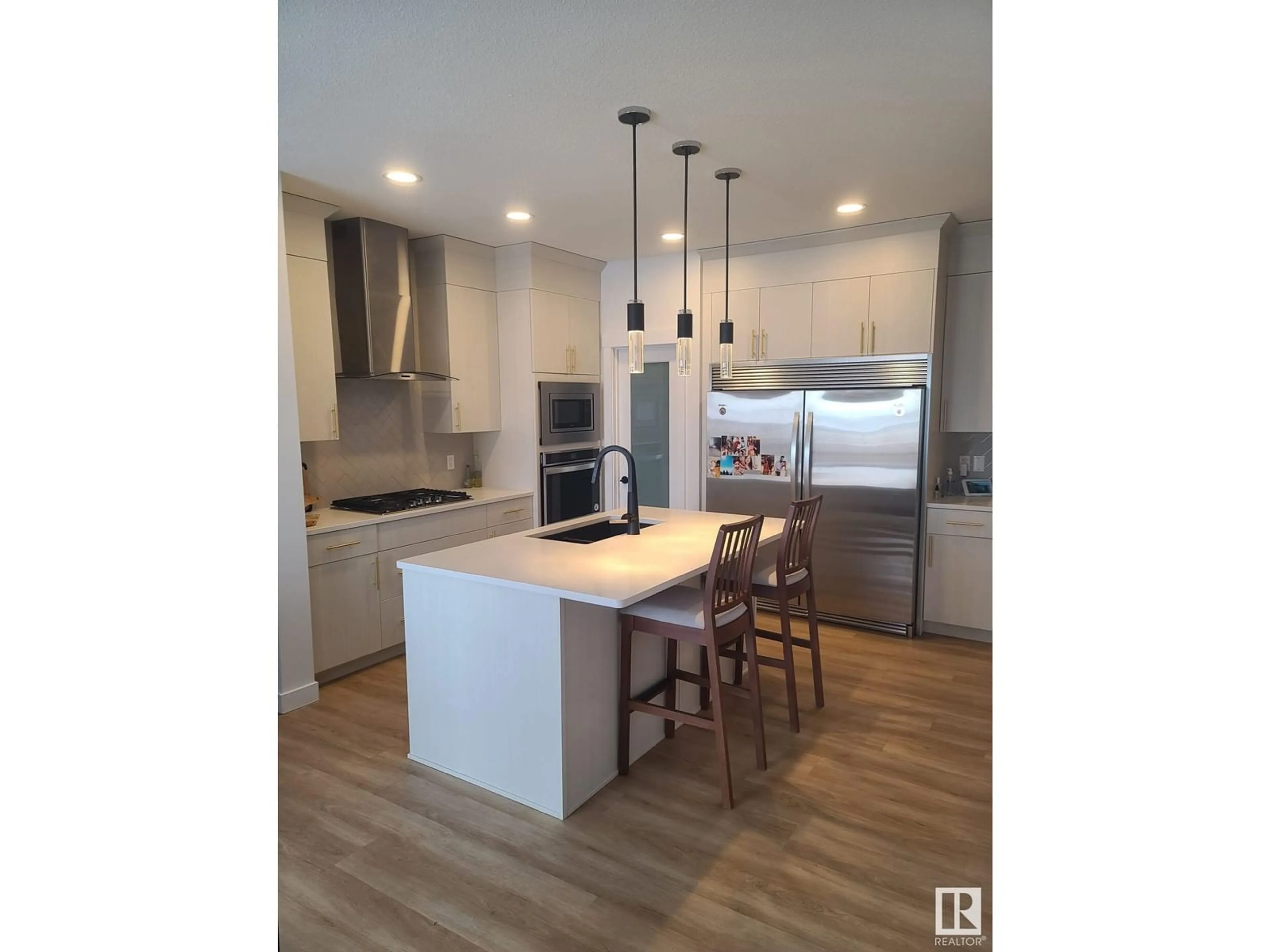 Open concept kitchen, wood/laminate floor for NW - 9981 205A ST, Edmonton Alberta T5T7N4