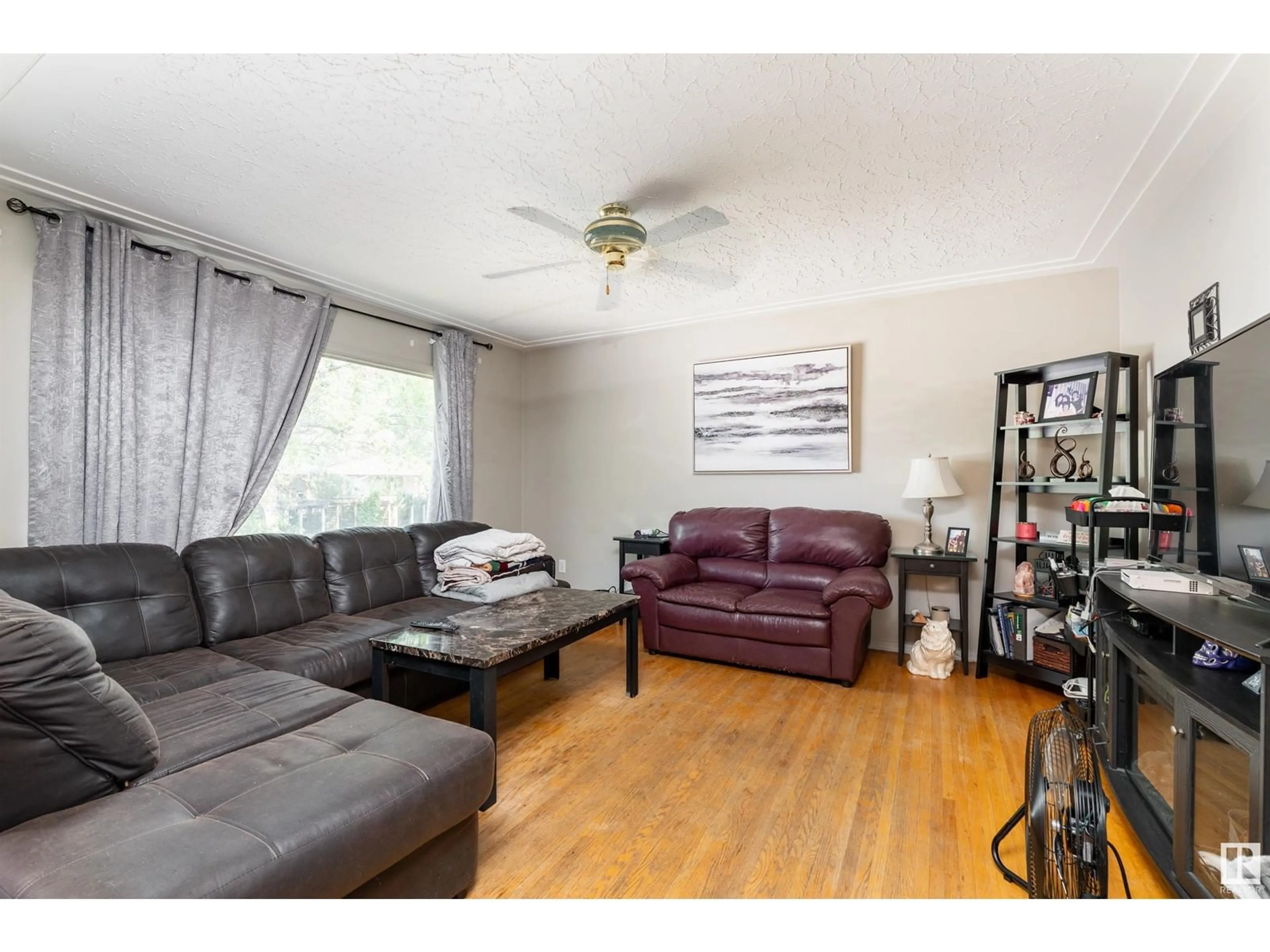 Living room with furniture, wood/laminate floor for 12915/12917 102 ST NW, Edmonton Alberta T5C4J4