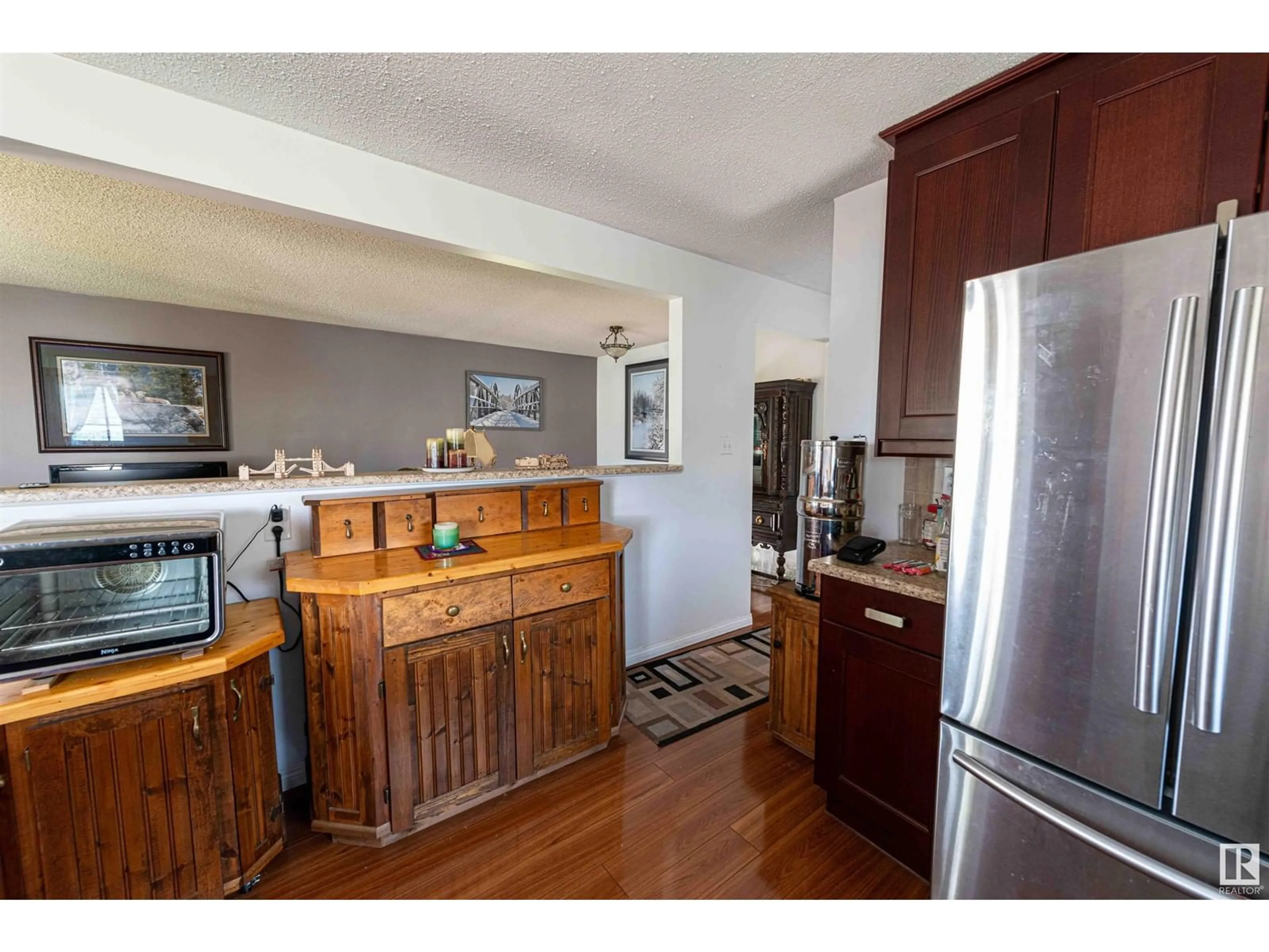 Open concept kitchen, wood/laminate floor for 5207 52 ST, Leduc Alberta T9E5L9