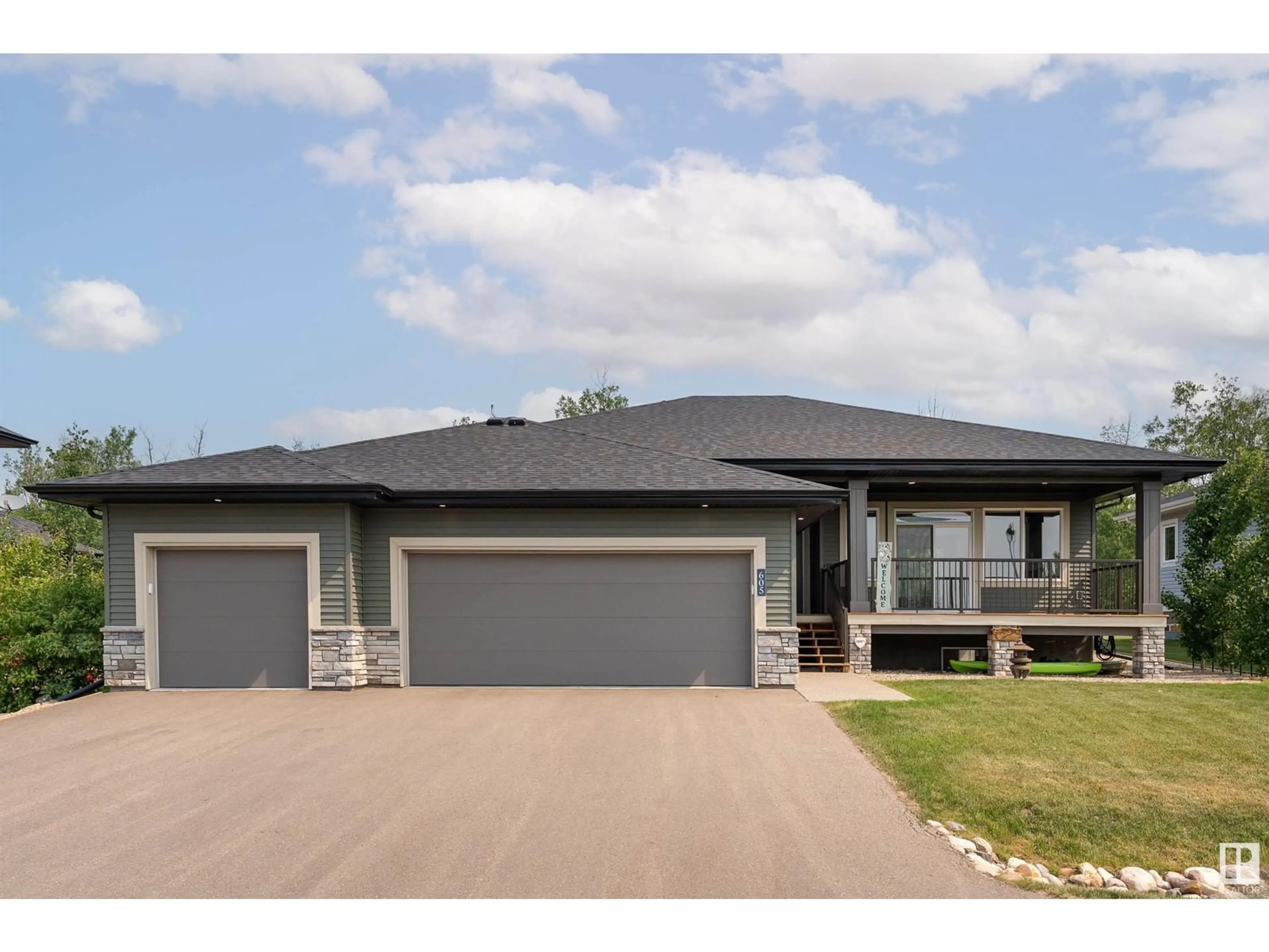 Home with brick exterior material, street for 55101 - 605 STE. ANNE TR, Rural Lac Ste. Anne County Alberta T0E1A1
