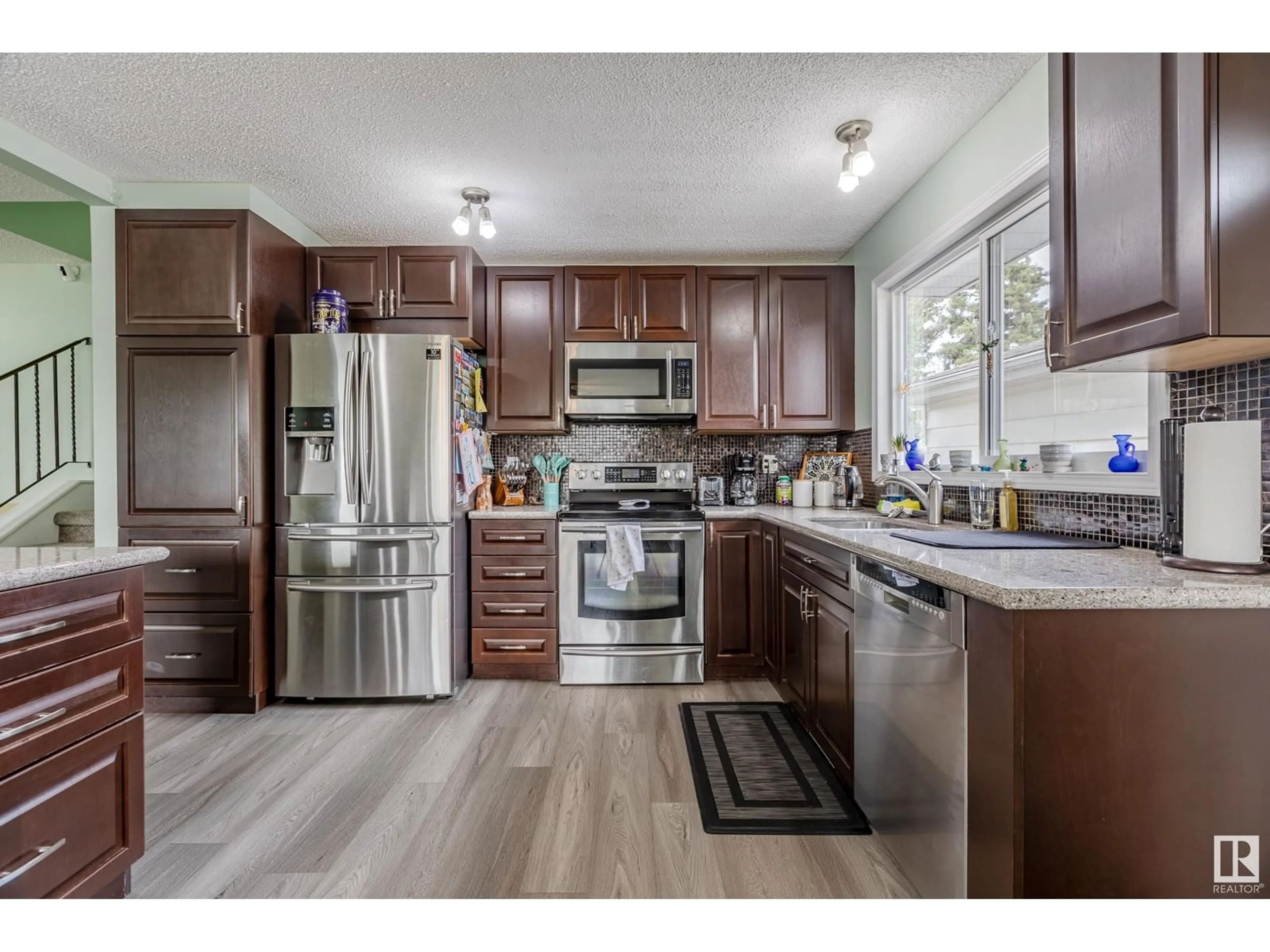 Open concept kitchen, wood/laminate floor for 9410 98 AV, Morinville Alberta T8R1J4