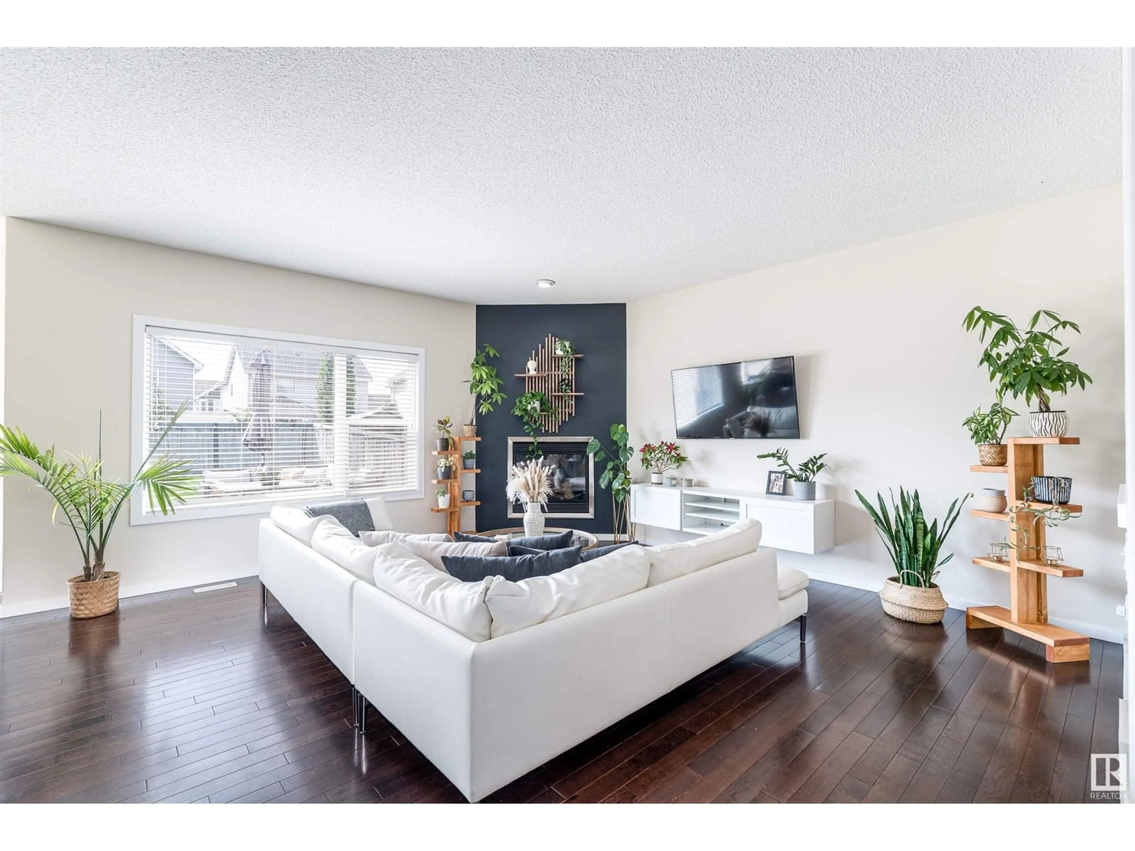 Living room with furniture, wood/laminate floor for 8715 10 AV SW, Edmonton Alberta T6X1J6