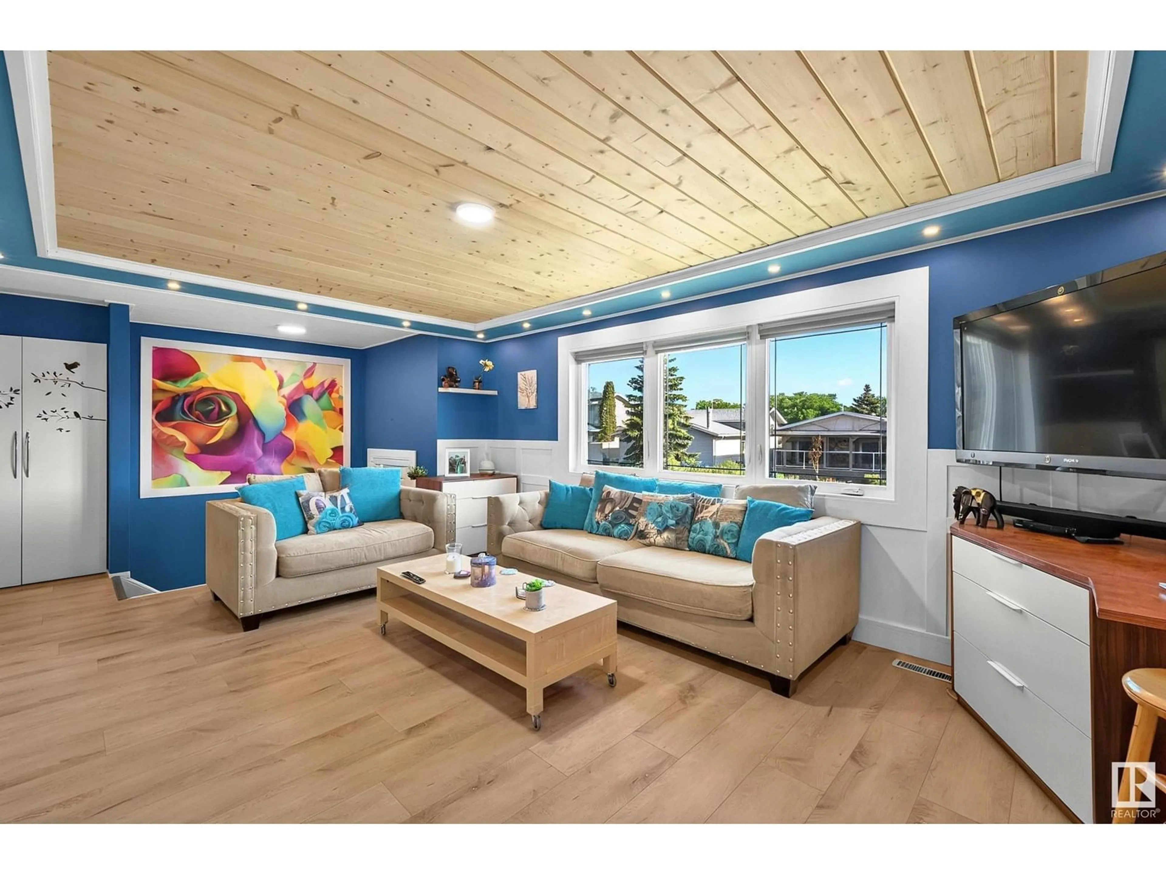 Living room with furniture, wood/laminate floor for NW - 11423 144 AV, Edmonton Alberta T5X1L7