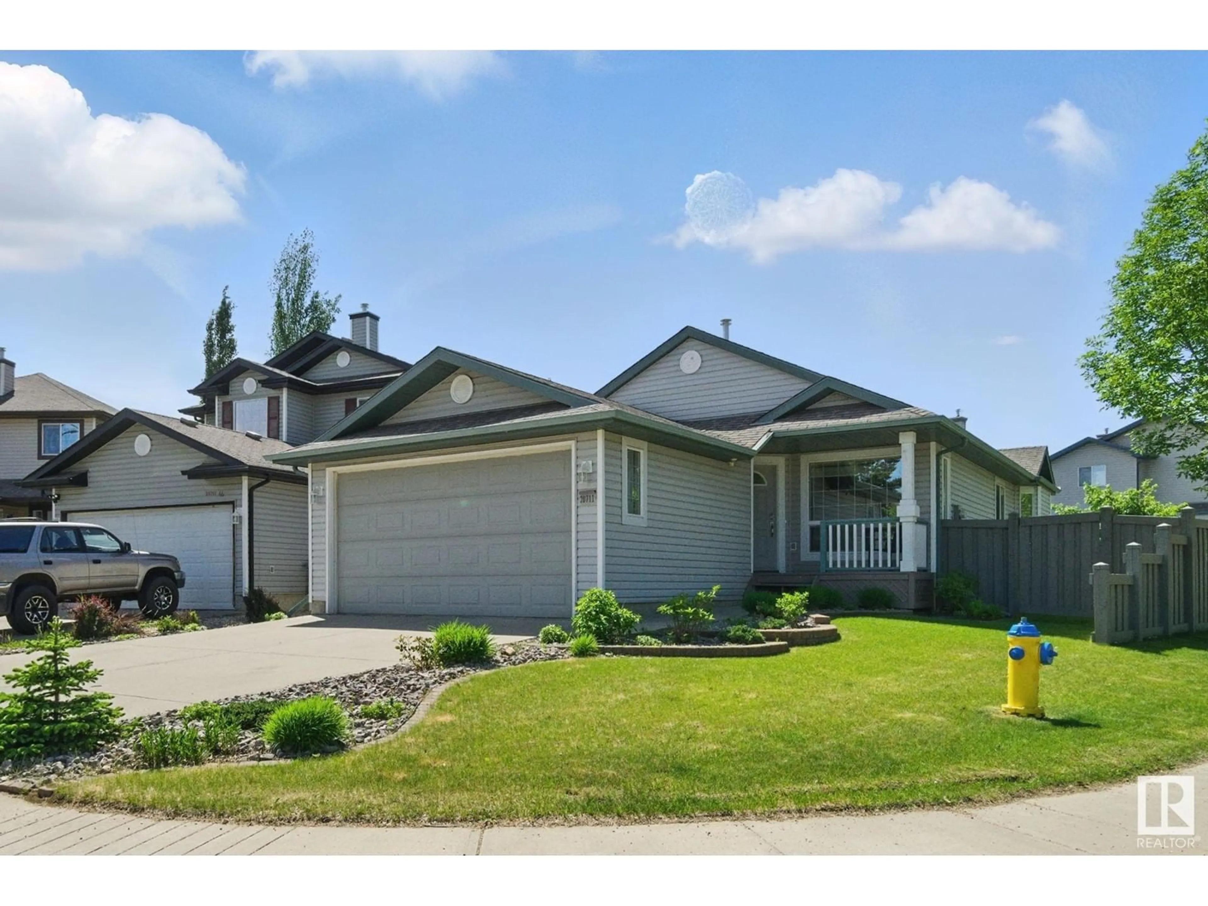 Home with vinyl exterior material, street for 20711 46 AV NW, Edmonton Alberta T6M0C2