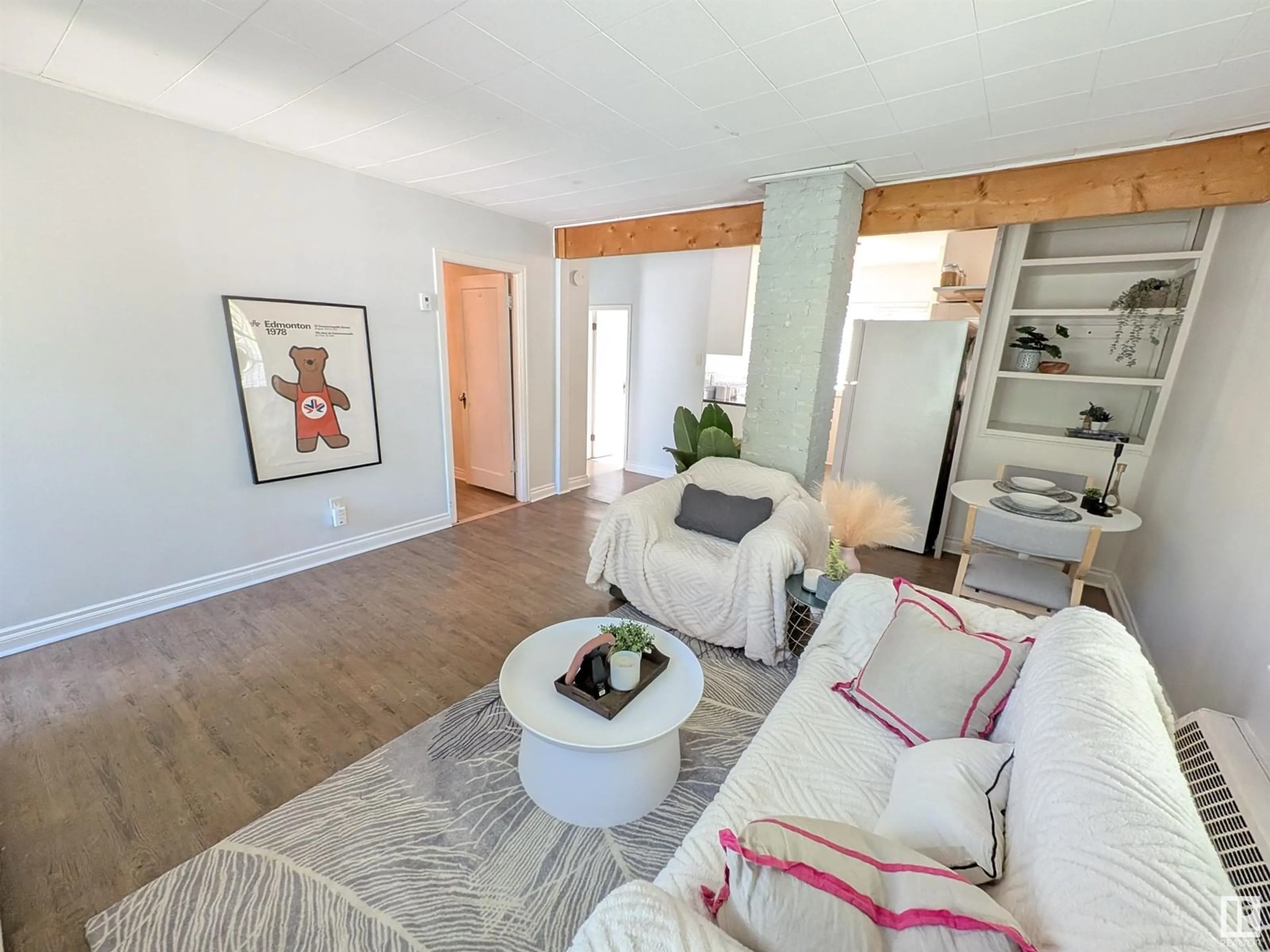 Living room with furniture, wood/laminate floor for 10633 76 AV, Edmonton Alberta T6E1L6