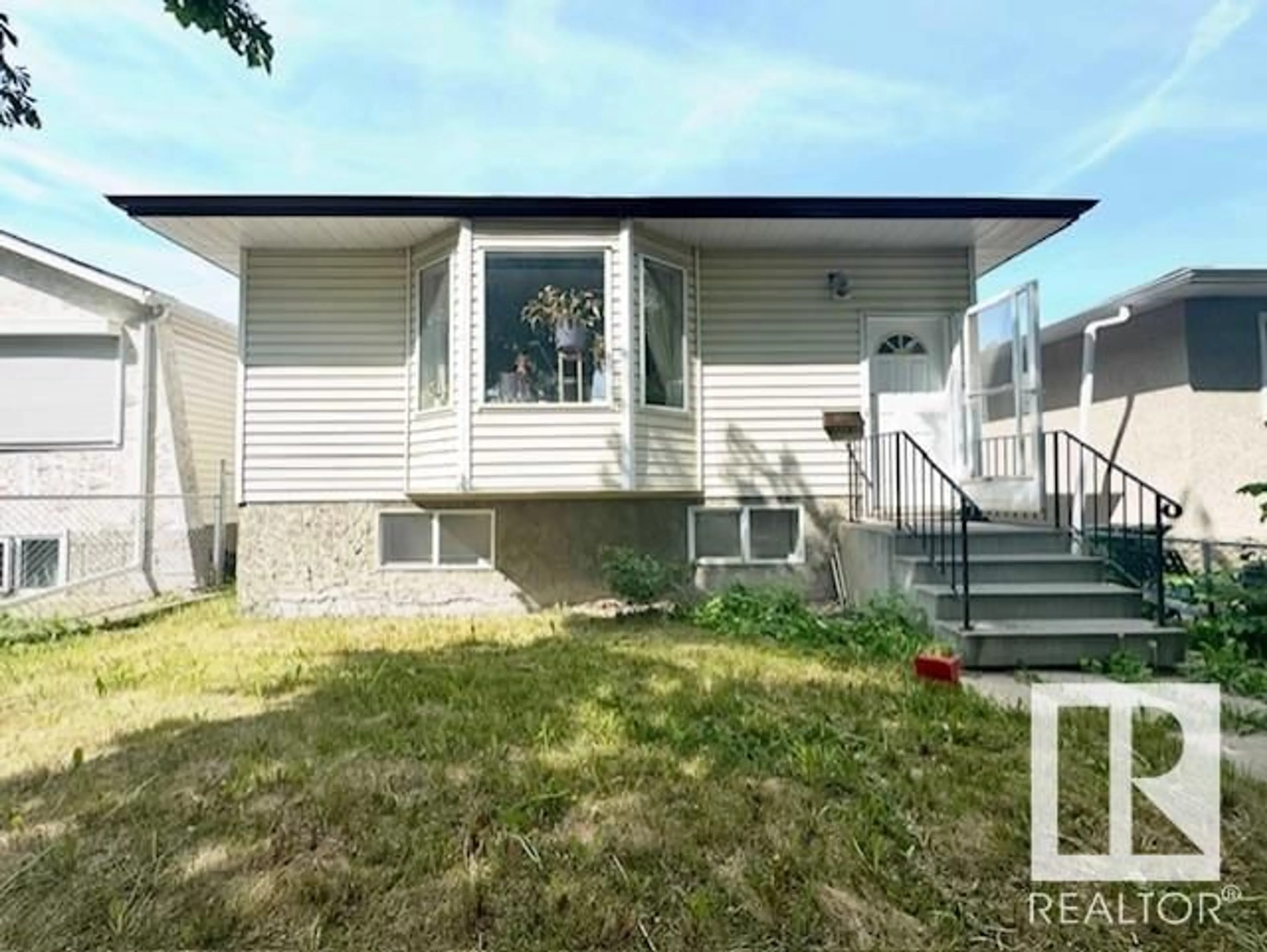 Home with vinyl exterior material, street for 11418 91 ST, Edmonton Alberta T5B4A5