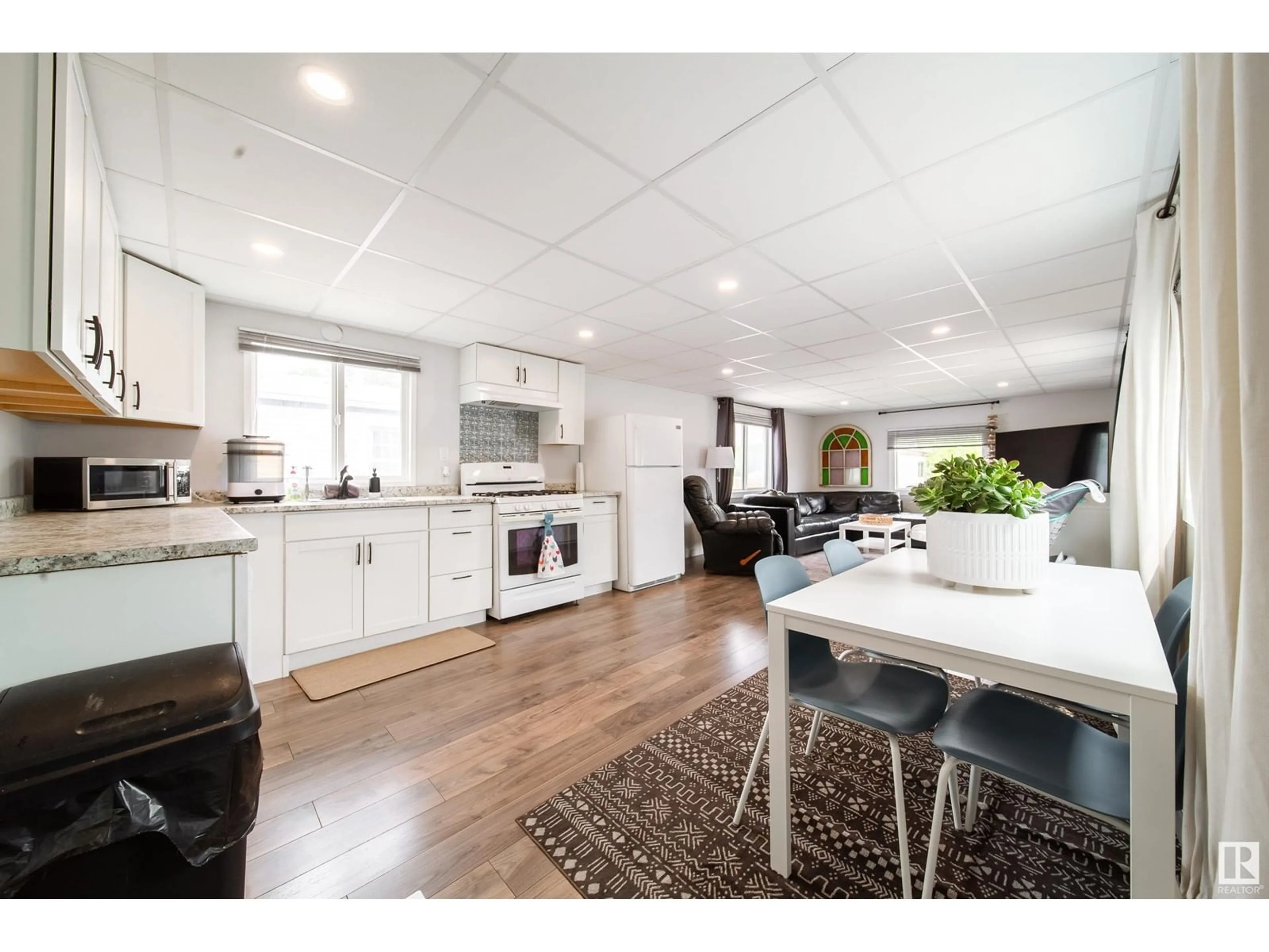 Open concept kitchen, wood/laminate floor for 13 - 10410 101A ST, Morinville Alberta T8R1B1