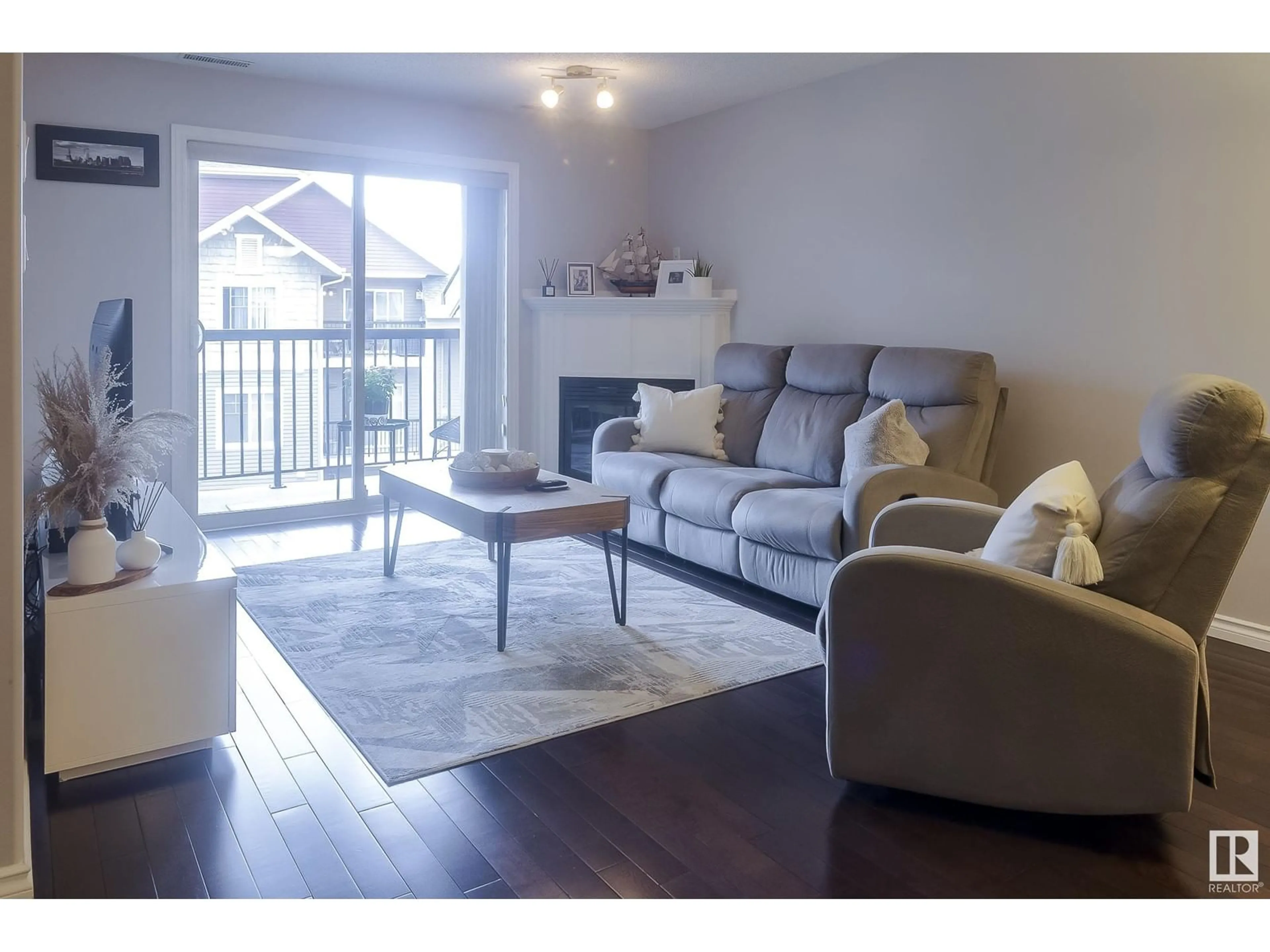 Living room with furniture, wood/laminate floor for 321 17415 99 AV, Edmonton Alberta T5T0W8
