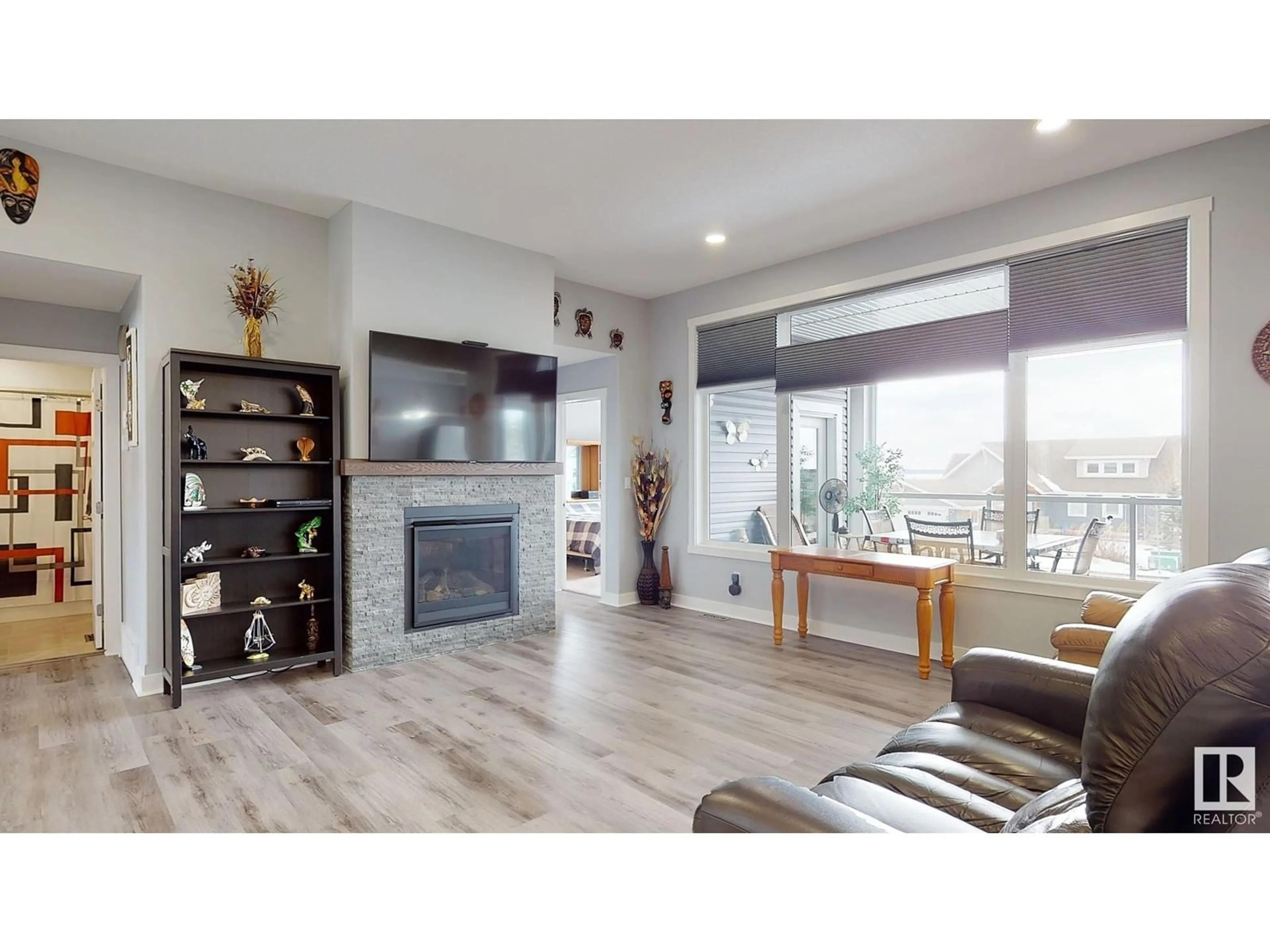Living room with furniture, wood/laminate floor for #213 - 55101 STE. ANNE TR, Rural Lac Ste. Anne County Alberta T0E0L0