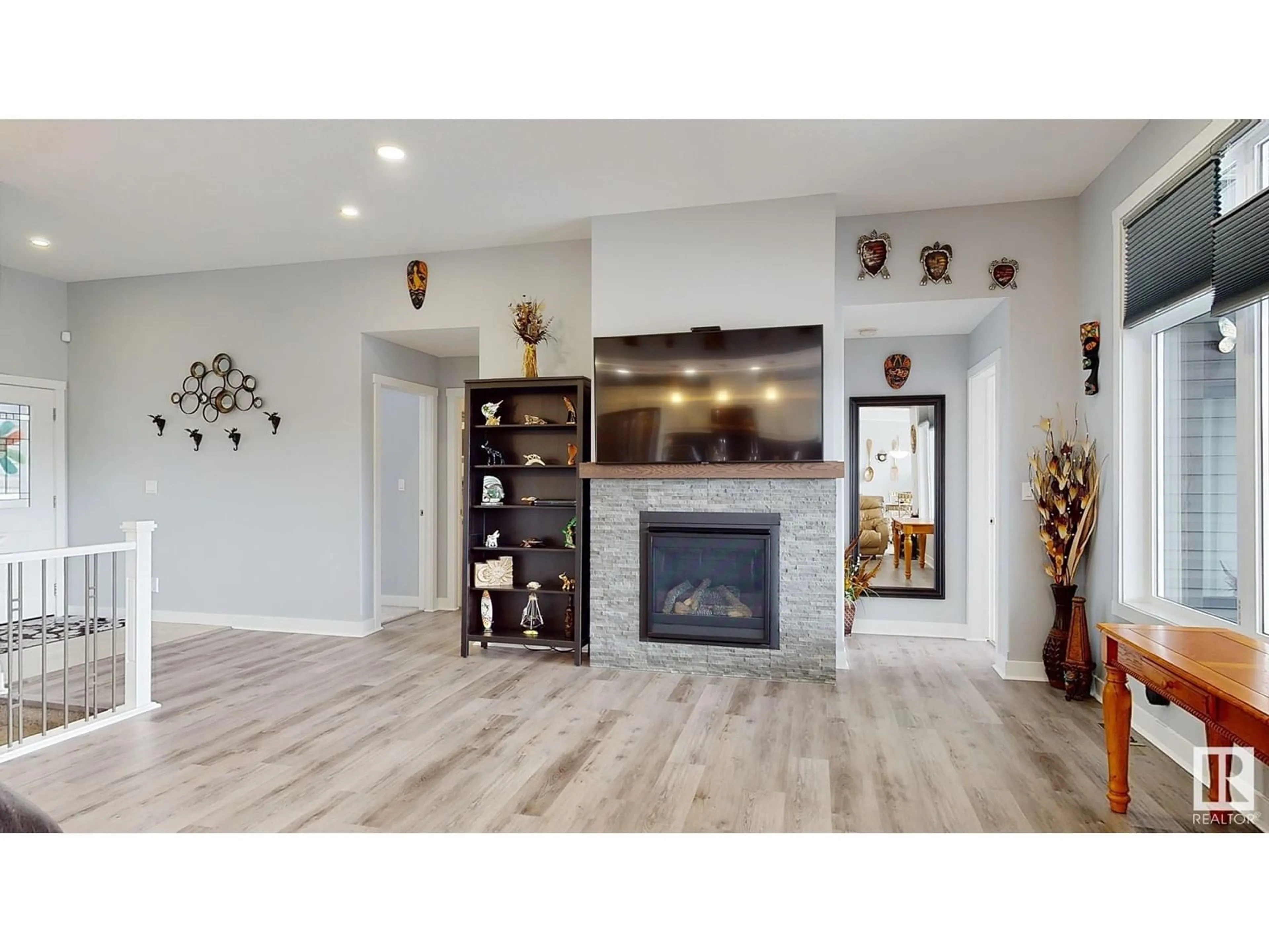 Living room with furniture, wood/laminate floor for #213 - 55101 STE. ANNE TR, Rural Lac Ste. Anne County Alberta T0E0L0