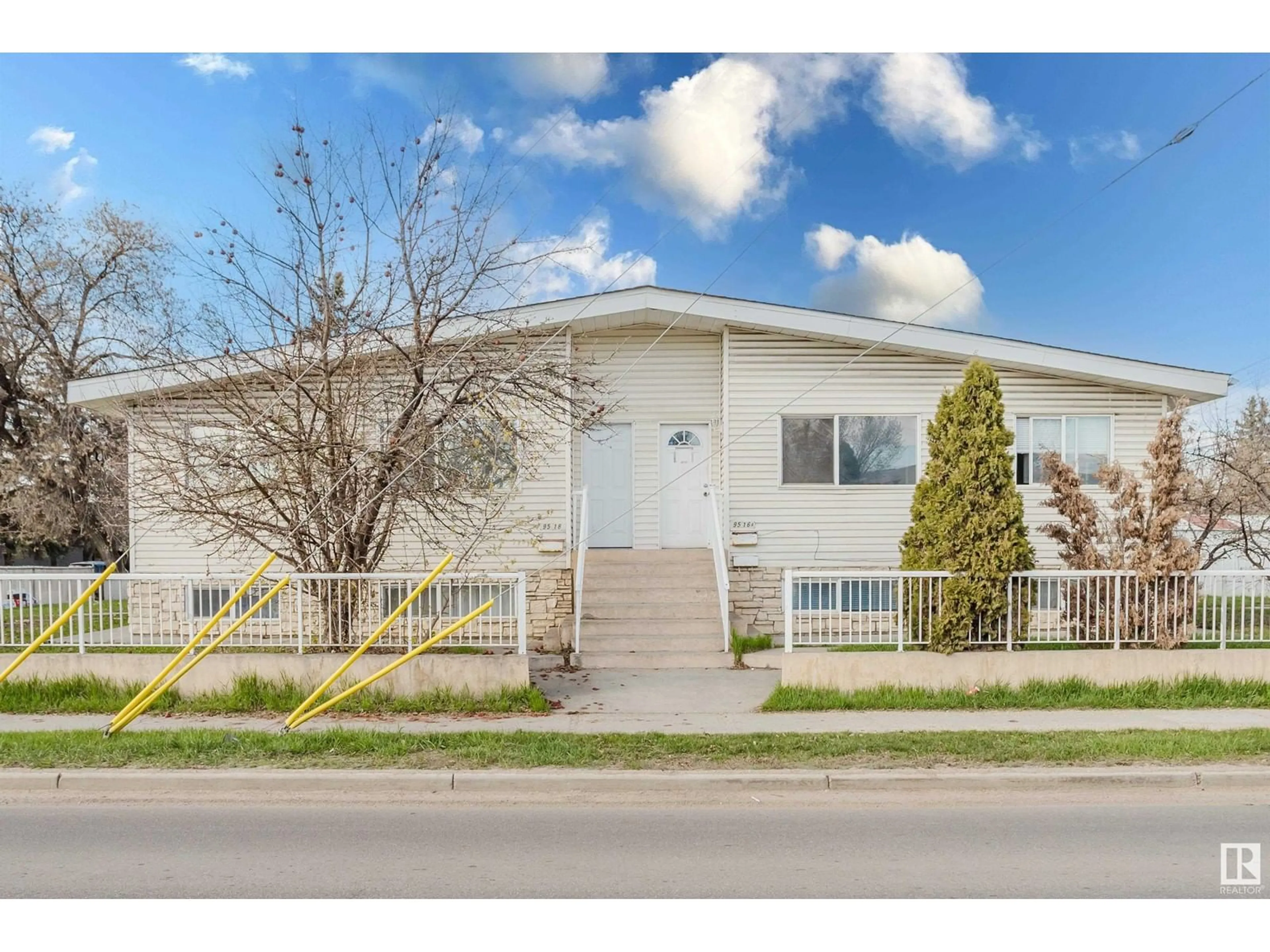 Home with vinyl exterior material, street for 9516 - 9518 127 AV, Edmonton Alberta T5E0B6