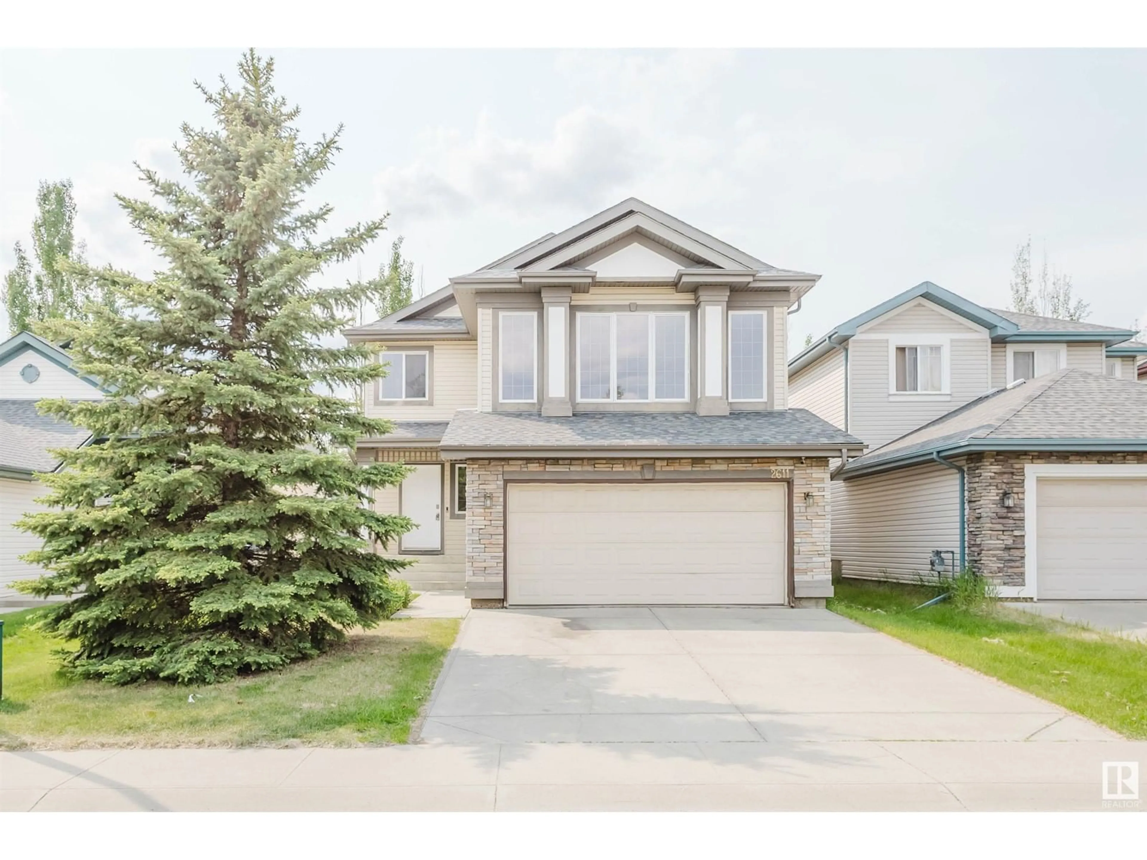 Home with vinyl exterior material, street for 2611 HANNA CR, Edmonton Alberta T6R3C9